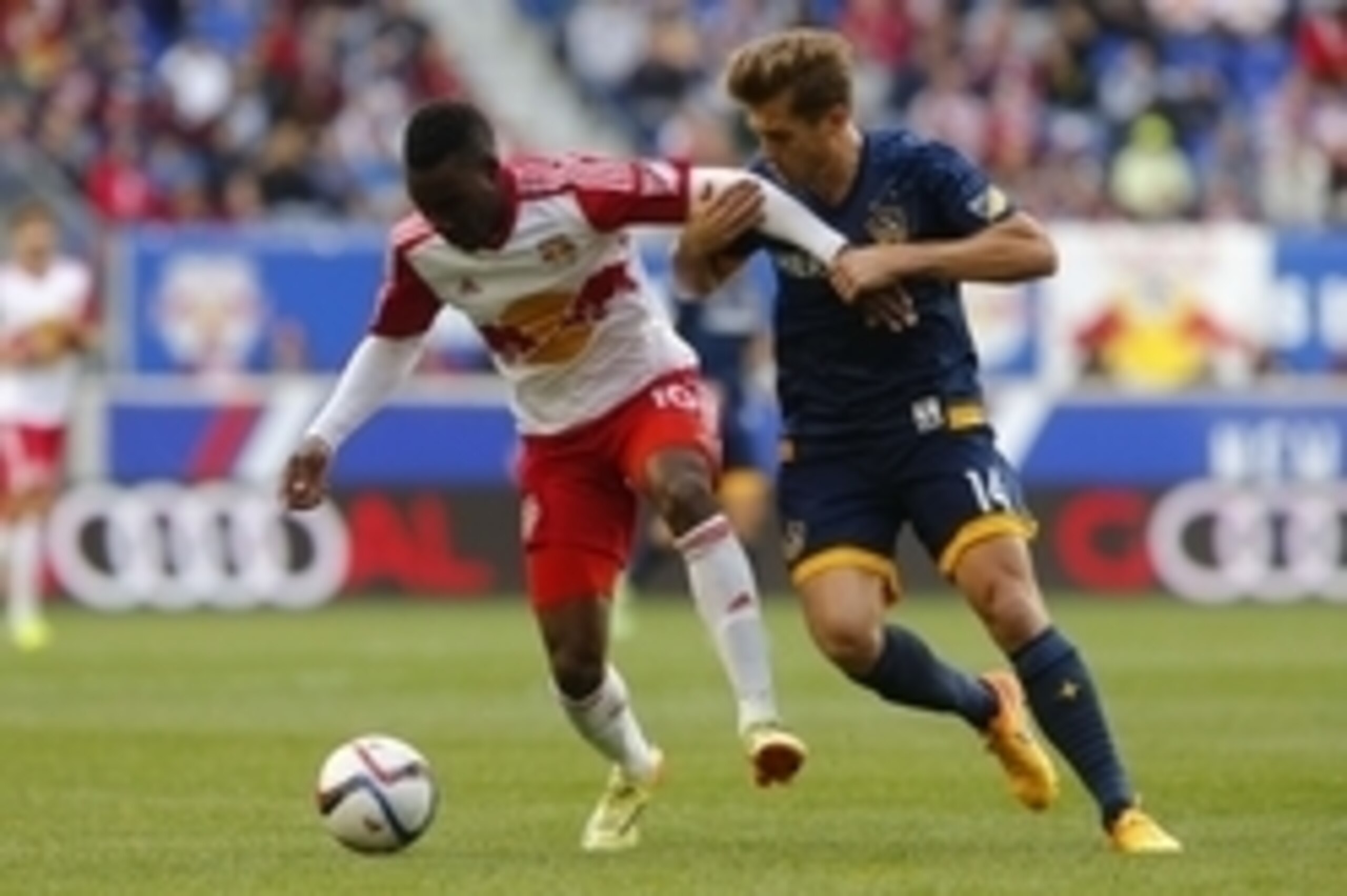 Apr 26, 2015; Harrison, NJ, USA; New York Red Bulls midfielder Lloyd Sam (10) controls the ball against Los Angeles Galaxy midfielder Robbie Rogers (14) during second half at Red Bull Arena. Final score 1-1.  Mandatory Credit: Noah K. Murray-USA TODAY Spo