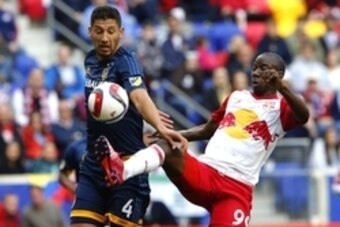 Apr 26, 2015; Harrison, NJ, USA; Los Angeles Galaxy defender Omar Gonzalez (4) defends a shot by New York Red Bulls forward Bradley Wright-Phillips (99) during first half at Red Bull Arena. Mandatory Credit: Noah K. Murray-USA TODAY Sports