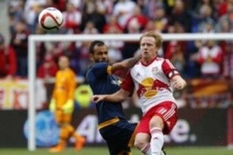 Apr 26, 2015; Harrison, NJ, USA; New York Red Bulls midfielder Dax McCarty (11) passes the ball away from Los Angeles Galaxy midfielder Juninho (19) during first half at Red Bull Arena. Mandatory Credit: Noah K. Murray-USA TODAY Sports