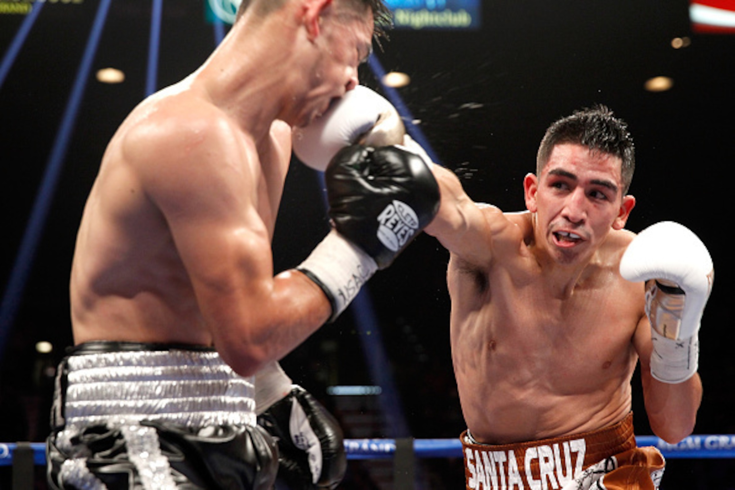 LAS VEGAS, NV - JANUARY 17:  WBC super bantamweight champion Leo Santa Cruz (R) connects with a punch on Jesus Ruiz during their title fight at the MGM Grand Garden Arena on January 17, 2015 in Las Vegas, Nevada. Santa Cruz retained his title with an eigh