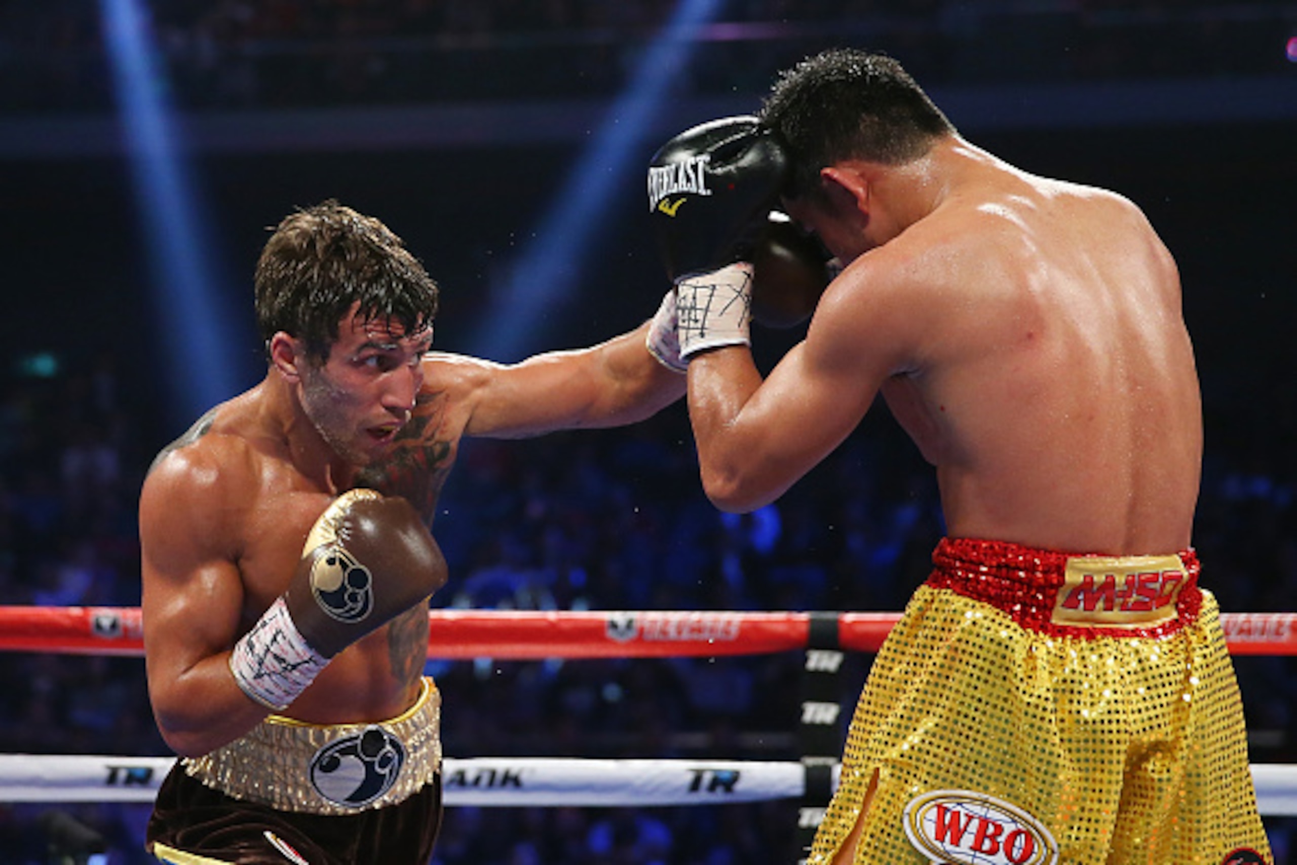 MACAU - NOVEMBER 23:  Vasyl Lomachenko of the Ukraine punches Chonlatarn Piriyapinyo of Thailand during the WBO Featherweight world title fight at The Venetian on November 23, 2014 in Macau, Macau.  (Photo by Chris Hyde/Getty Images)