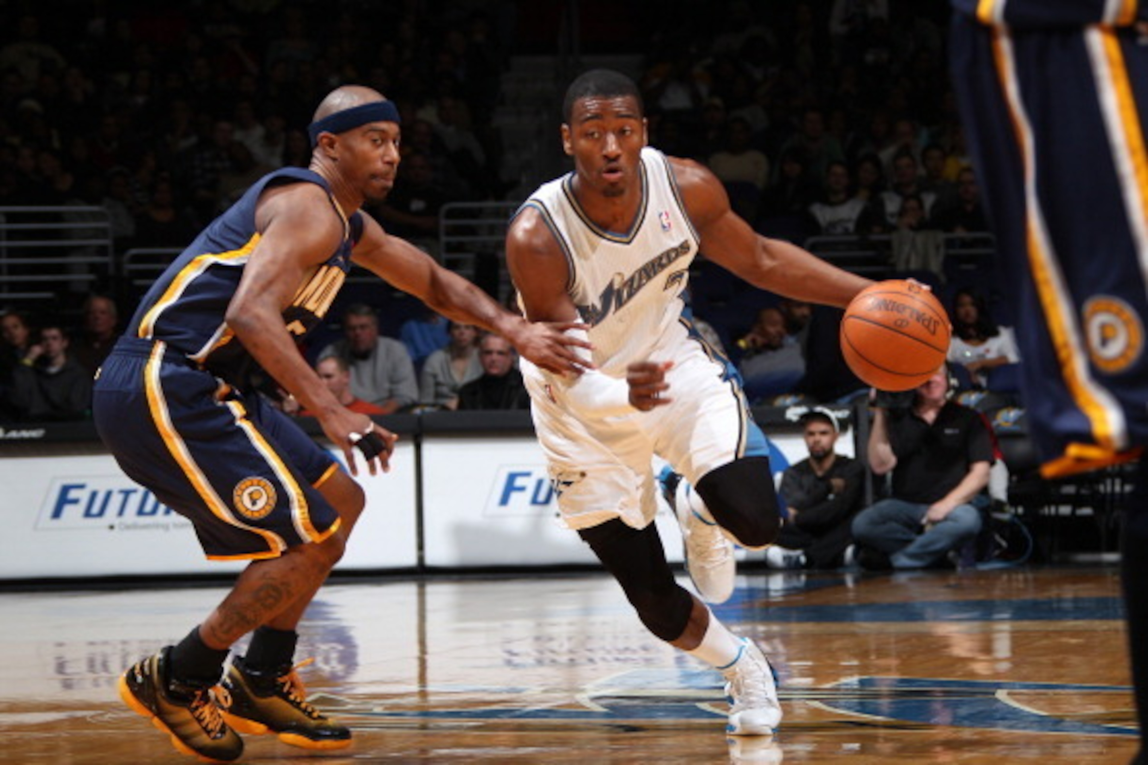 WASHINGTON - DECEMBER 29: John Wall #2 of the Washington Wizards drives against T.J. Ford #5 of the Indiana Pacers at the Verizon Center on December 29, 2010 in Washington, DC. NOTE TO USER: User expressly acknowledges and agrees that, by downloading and