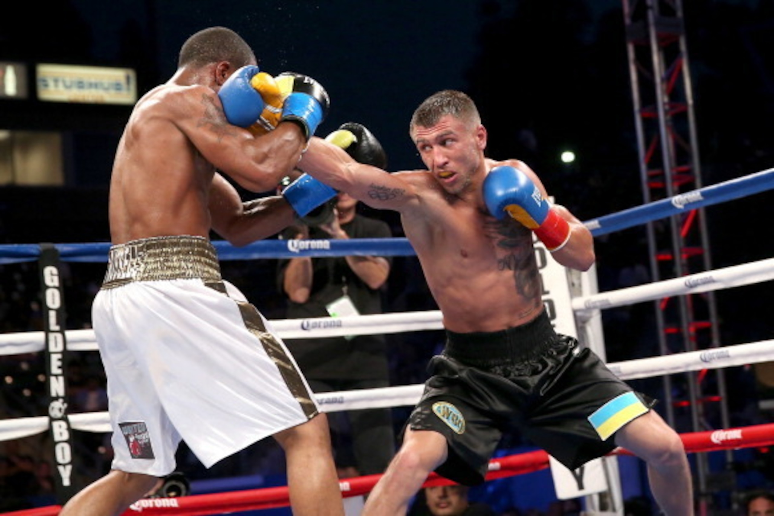 LOS ANGELES, CA - JUNE 21:  Vasyl Lomachenko (R) throws a punch at Gary Russell Jr. in their WBO Featherwieight Title bout at StubHub Center on June 21, 2014 in Los Angeles, California.  Lomachenko won by split decision.  (Photo by Stephen Dunn/Getty Imag