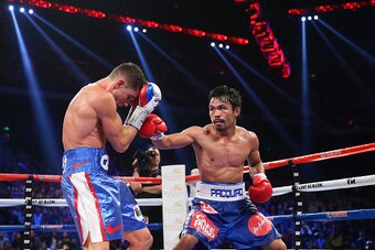 MACAU - NOVEMBER 23:  Manny Pacquiao of the Philippines punches Chris Algieri of the United States during the WBO world welterweight title at The Venetian on November 23, 2014 in Macau, Macau.  (Photo by Chris Hyde/Getty Images)