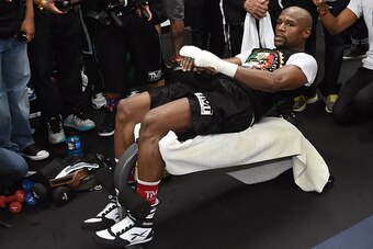 LAS VEGAS, NV - APRIL 14:  WBC/WBA welterweight champion Floyd Mayweather Jr. does situps as he works out at the Mayweather Boxing Club on April 14, 2015 in Las Vegas, Nevada. Mayweather will face WBO welterweight champion Manny Pacquiao in a unification 