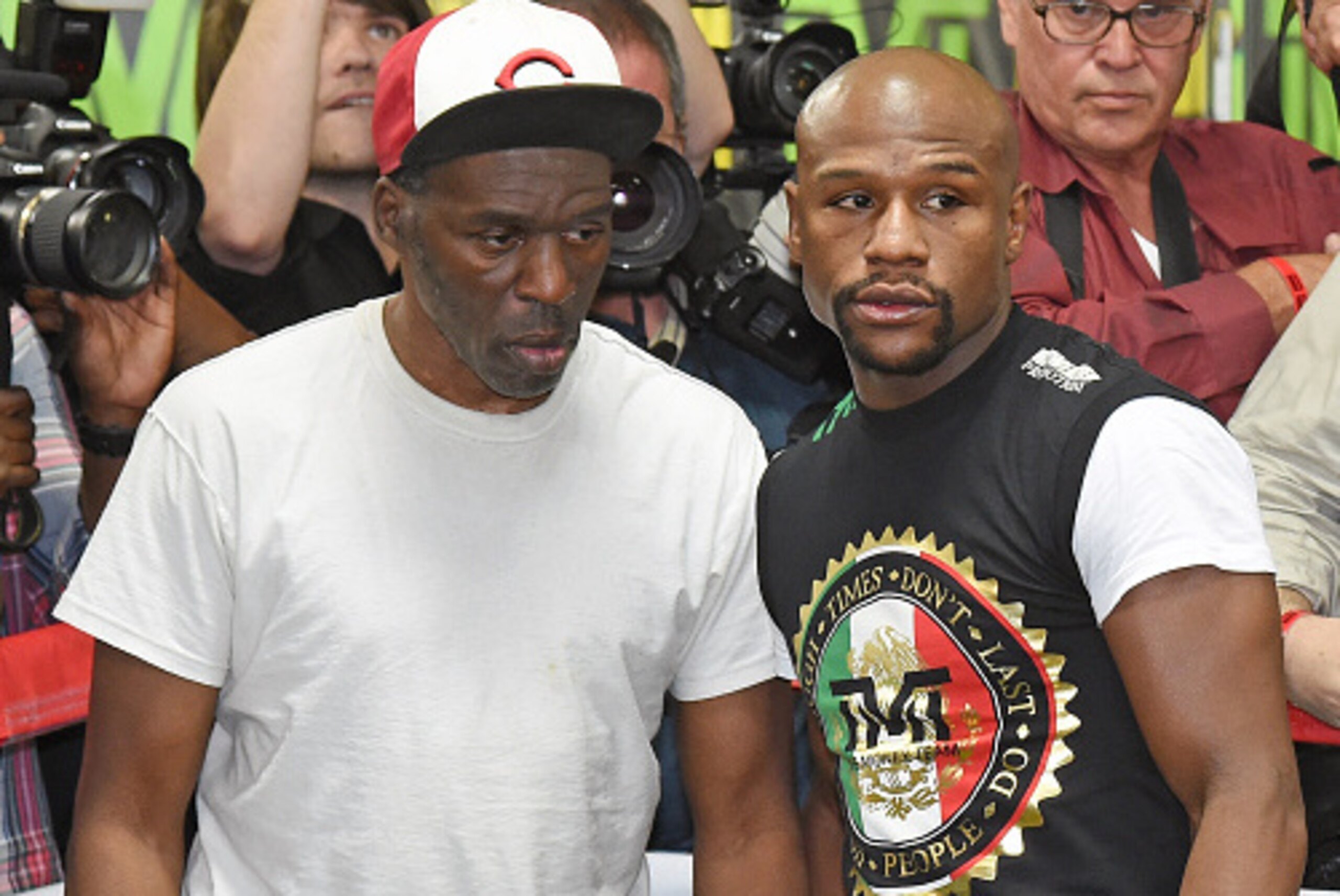LAS VEGAS, NV - APRIL 14:  Roger Mayweather (L) and his nephew, WBC/WBA welterweight champion Floyd Mayweather Jr., talk during a workout at the Mayweather Boxing Club on April 14, 2015 in Las Vegas, Nevada. Mayweather Jr. will face WBO welterweight champ