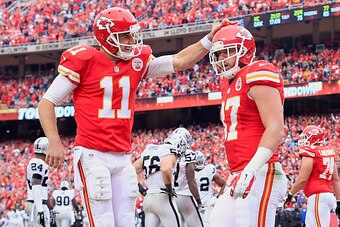 KANSAS CITY, MO - DECEMBER 14:   Alex Smith #11 of the Kansas City Chiefs celebrates a touchdown with Travis Kelce #87 during the game against the Oakland Raiders  at Arrowhead Stadium on December 14, 2014 in Kansas City, Missouri.  (Photo by Jamie Squire