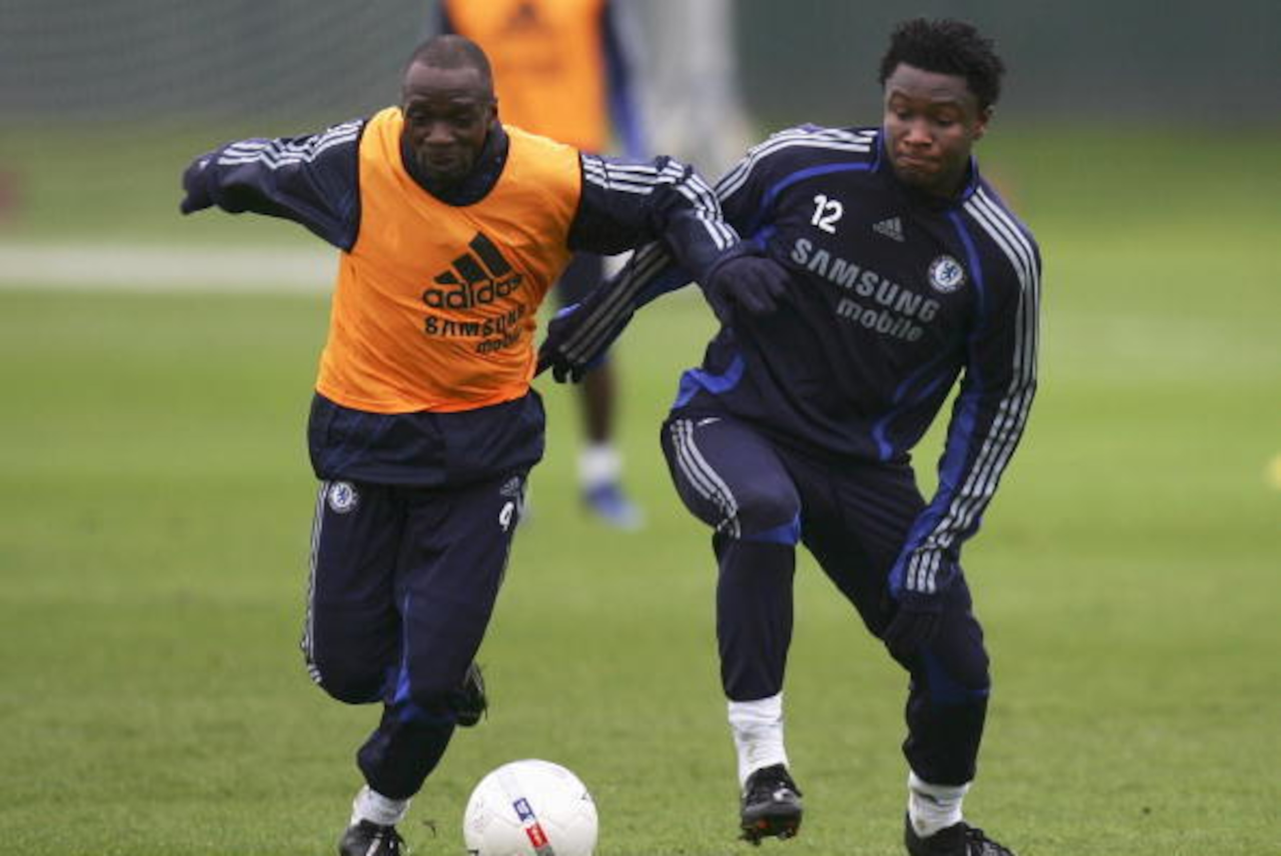 COBHAM, UNITED KINGDOM - FEBRUARY 14:  John Mikel (R) of Chelsea battles for the ball with Claude Makelele (L) during a Chelsea training session with the Chinese national football team at Chelsea's training ground on February 14, 2007 in Cobham, England. 