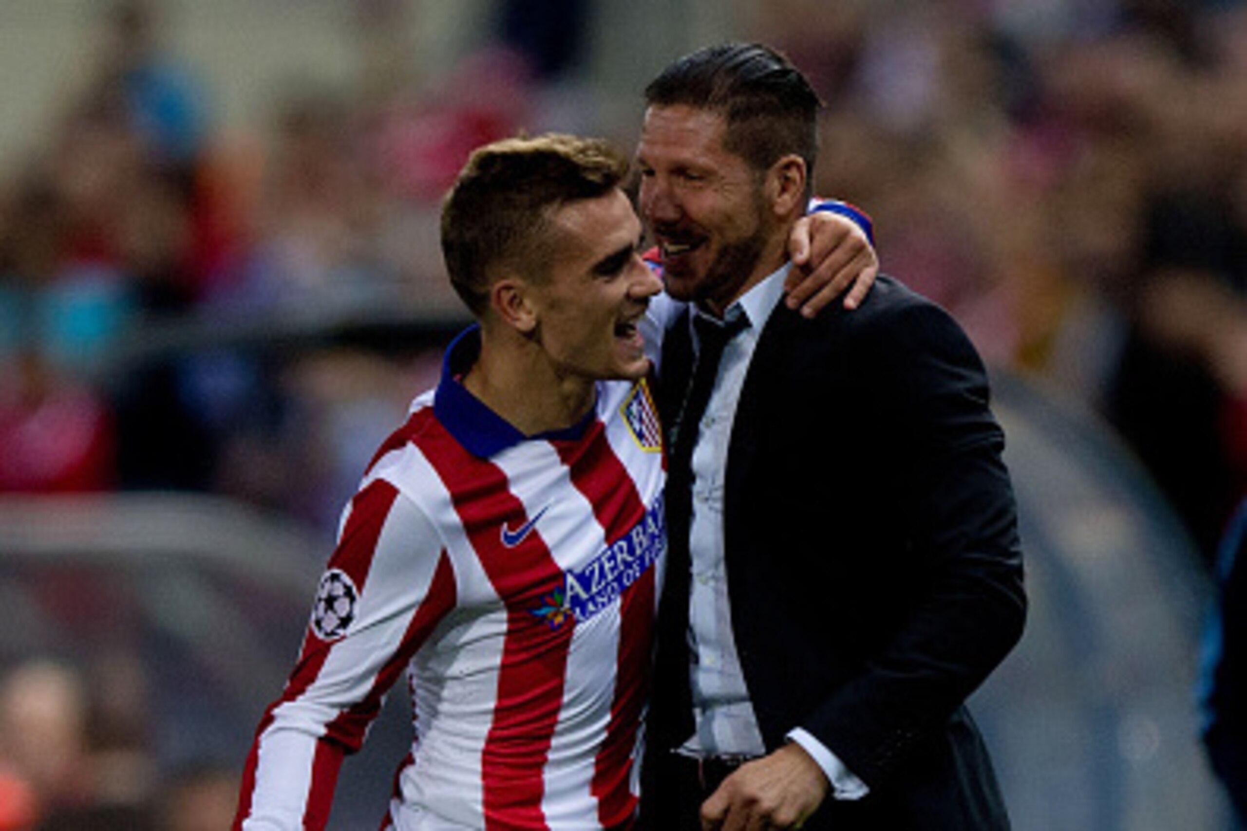 MADRID, SPAIN - OCTOBER 22:  Antoine Griezmann (L) of Atletico de Madrid embraces head coach Diego Pablo Simeone (R) to celebrate scoring their third goal during the UEFA Champions League group A match between Club Atletico de Madrid and Malmo FF at Vicen