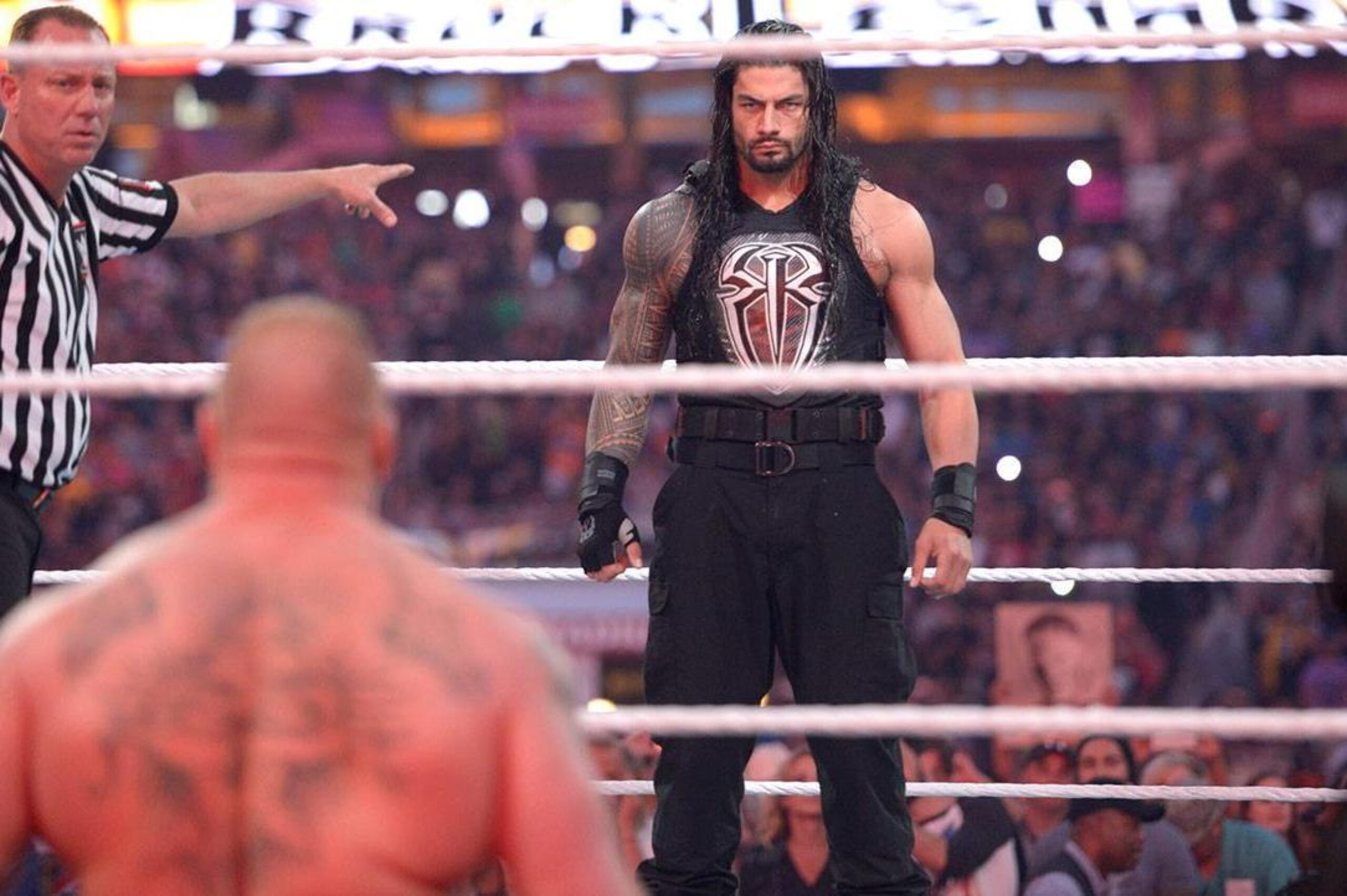 Roman Reigns stares down Brock Lesnar.