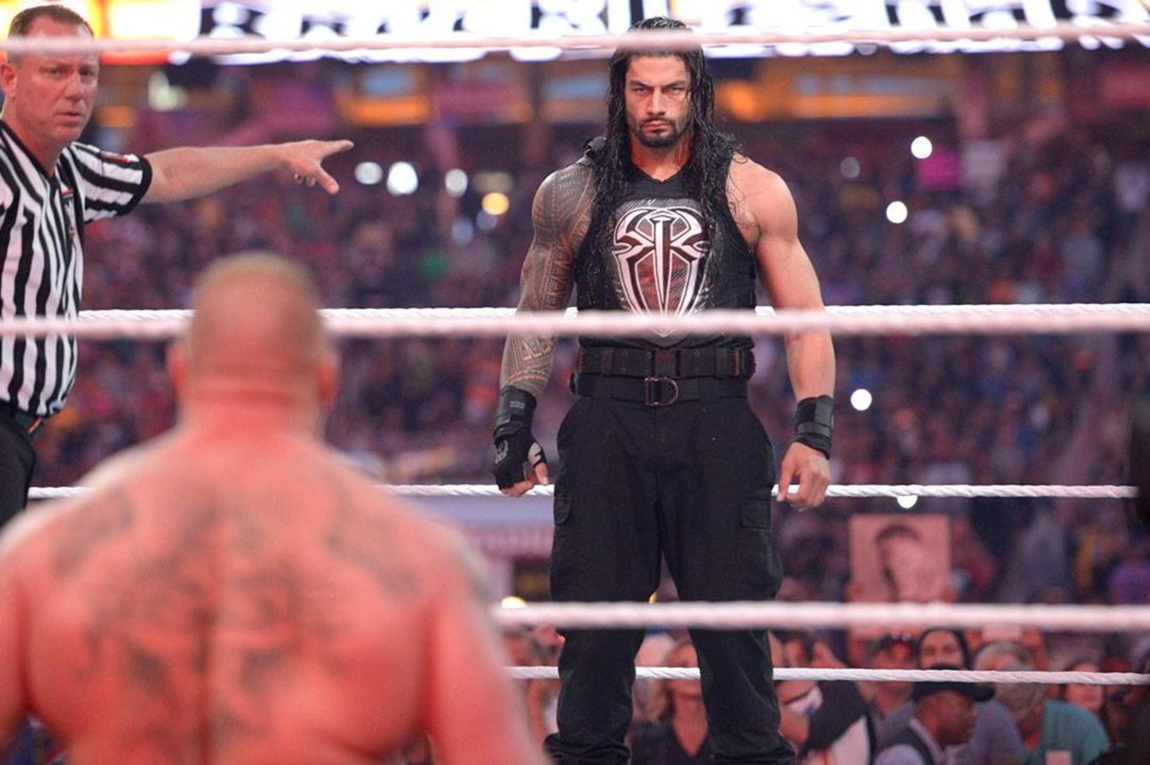 Roman Reigns stares down Brock Lesnar.