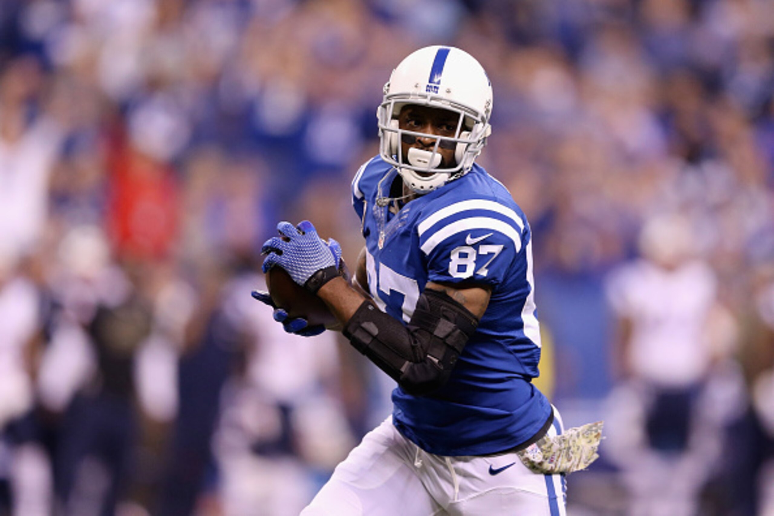 INDIANAPOLIS, IN - NOVEMBER 16:  Reggie Wayne #87 of the Indianapolis Colts runs with the ball against the New England Patriots during the first quarter of the game at Lucas Oil Stadium on November 16, 2014 in Indianapolis, Indiana.  (Photo by Andy Lyons/