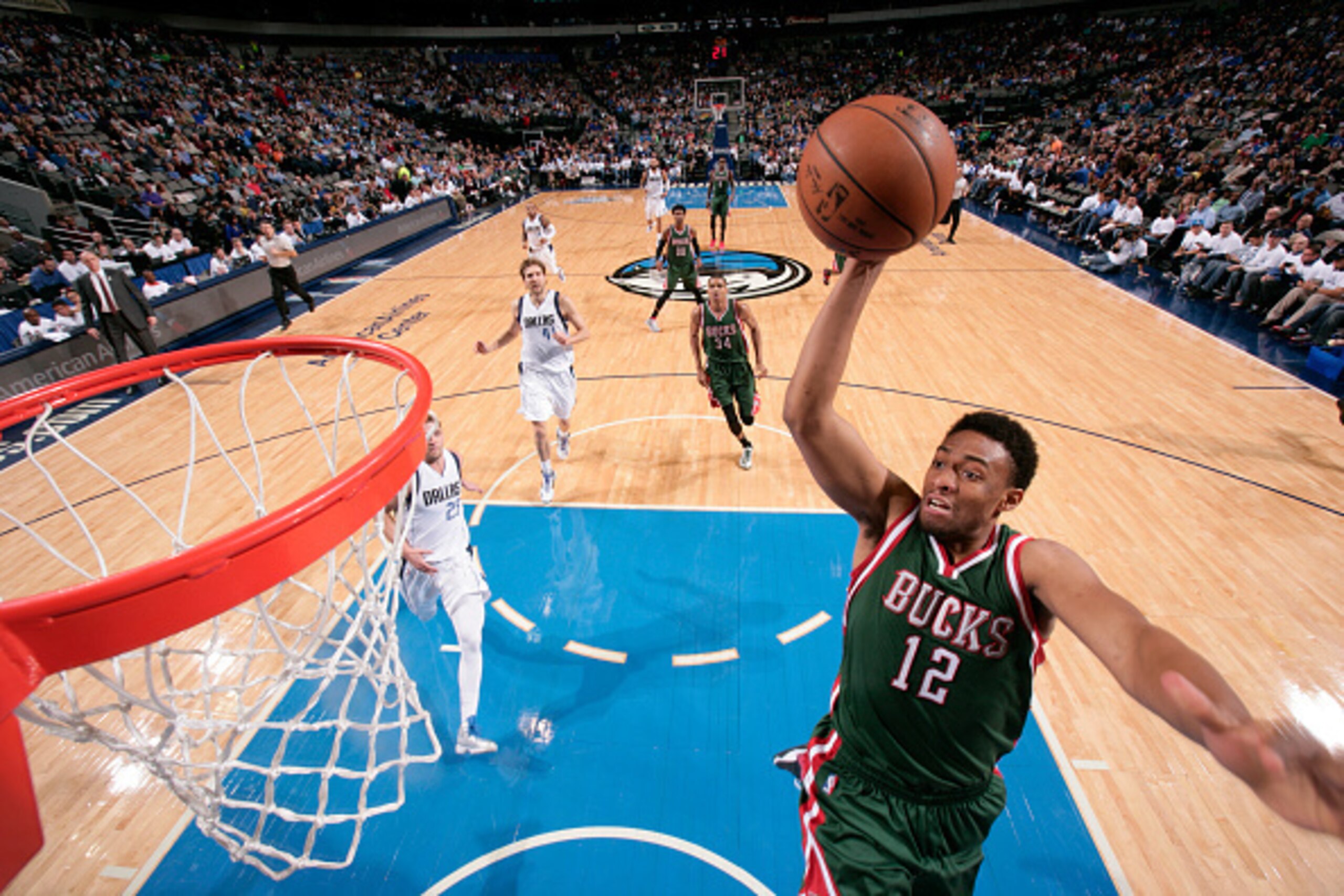 DALLAS, TX - DECEMBER 7: Jabari Parker #12 of the Milwaukee Bucks dunks against the Dallas Mavericks on December 7, 2014 at the American Airlines Center in Dallas, Texas. NOTE TO USER: User expressly acknowledges and agrees that, by downloading and or usi