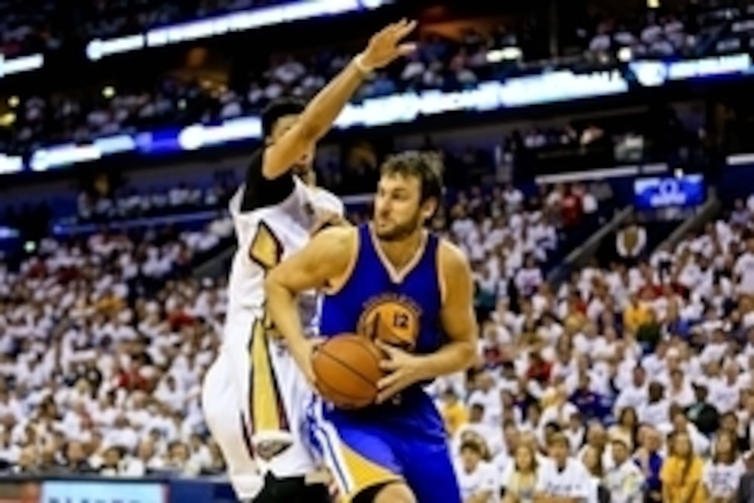 Apr 25, 2015; New Orleans, LA, USA; Golden State Warriors center Andrew Bogut (12) drives past New Orleans Pelicans forward Anthony Davis (23) during the first half in game four of the first round of the NBA Playoffs at the Smoothie King Center. Mandatory