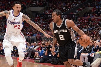 LOS ANGELES, CA - APRIL 28:  Kawhi Leonard #2 of the San Antonio Spurs drives to the basket Matt Barnes #22 of the Los Angeles Clippers in Game Five of the Western Conference Quarterfinals during the 2015 NBA Playoffs on April 28, 2015 at Staples Center i
