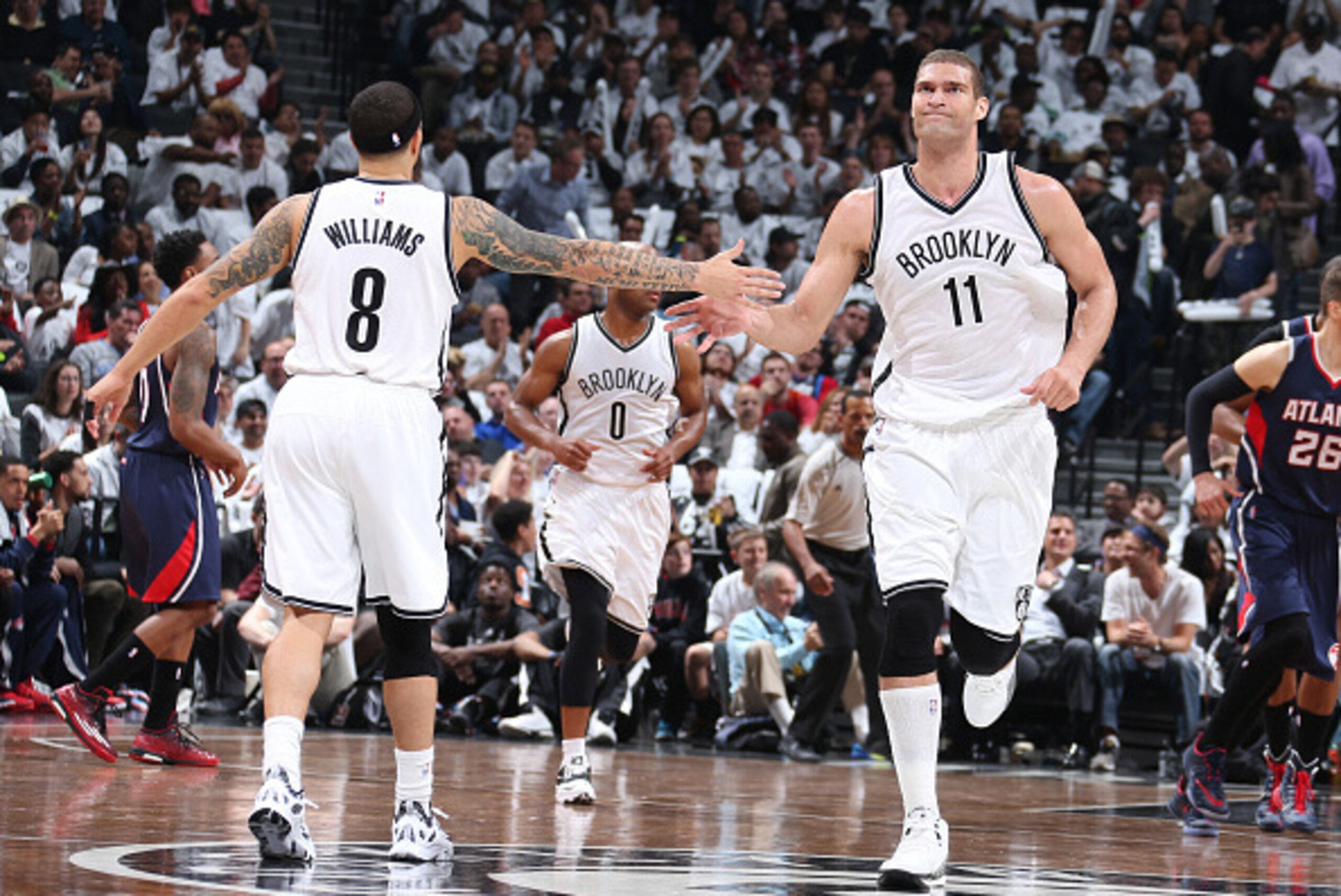 BROOKLYN, NY - APRIL 27: Deron Williams #8 high fives teammate Brook Lopez #11 of the Brooklyn Nets during Game Four of the Eastern Conference Quarterfinals against the Atlanta Hawks during the NBA Playoffs on April 27, 2015 at Barclays Center in Brooklyn