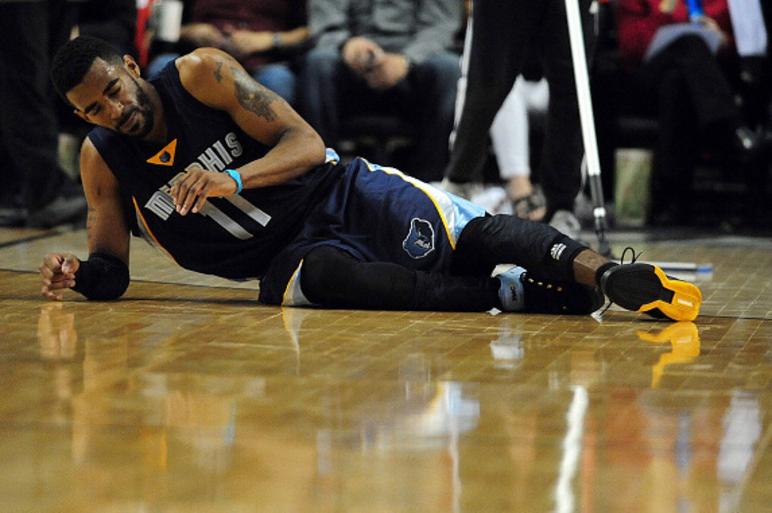 PORTLAND, OR - APRIL 25: Mike Conley #11 of the Memphis Grizzlies rolls over on the court after being injured during the third quarter in Game Three of the Western Conference quarterfinals against the Portland Trail Blazers during the 2015 NBA Playoffs at