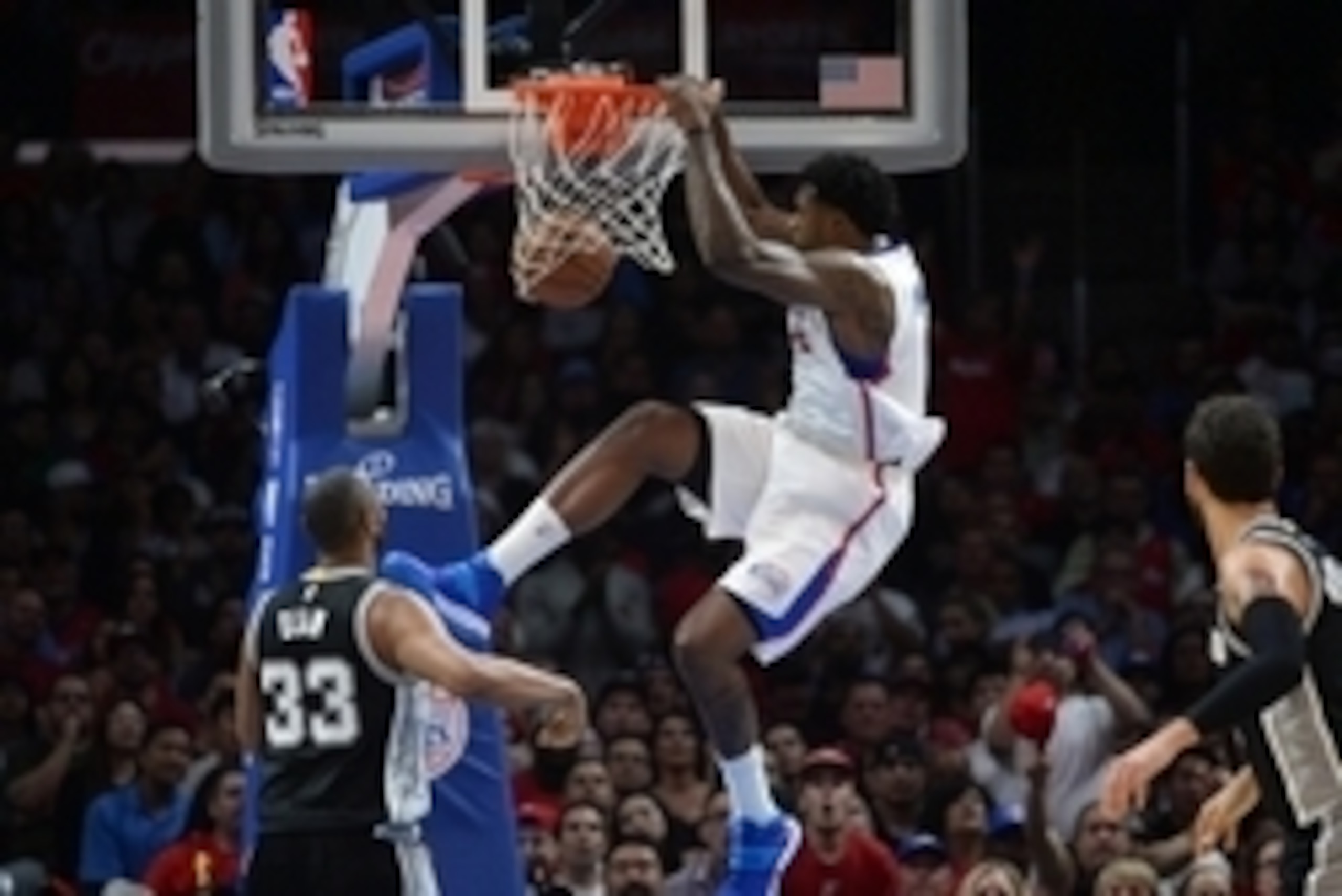 Apr 28, 2015; Los Angeles, CA, USA; Los Angeles Clippers center DeAndre Jordan (6) dunks the ball as San Antonio Spurs players Boris Diaw (33) and Marco Belinelli (3) watch in game five of the first round of the NBA Playoffs at Staples Center. The Spurs d