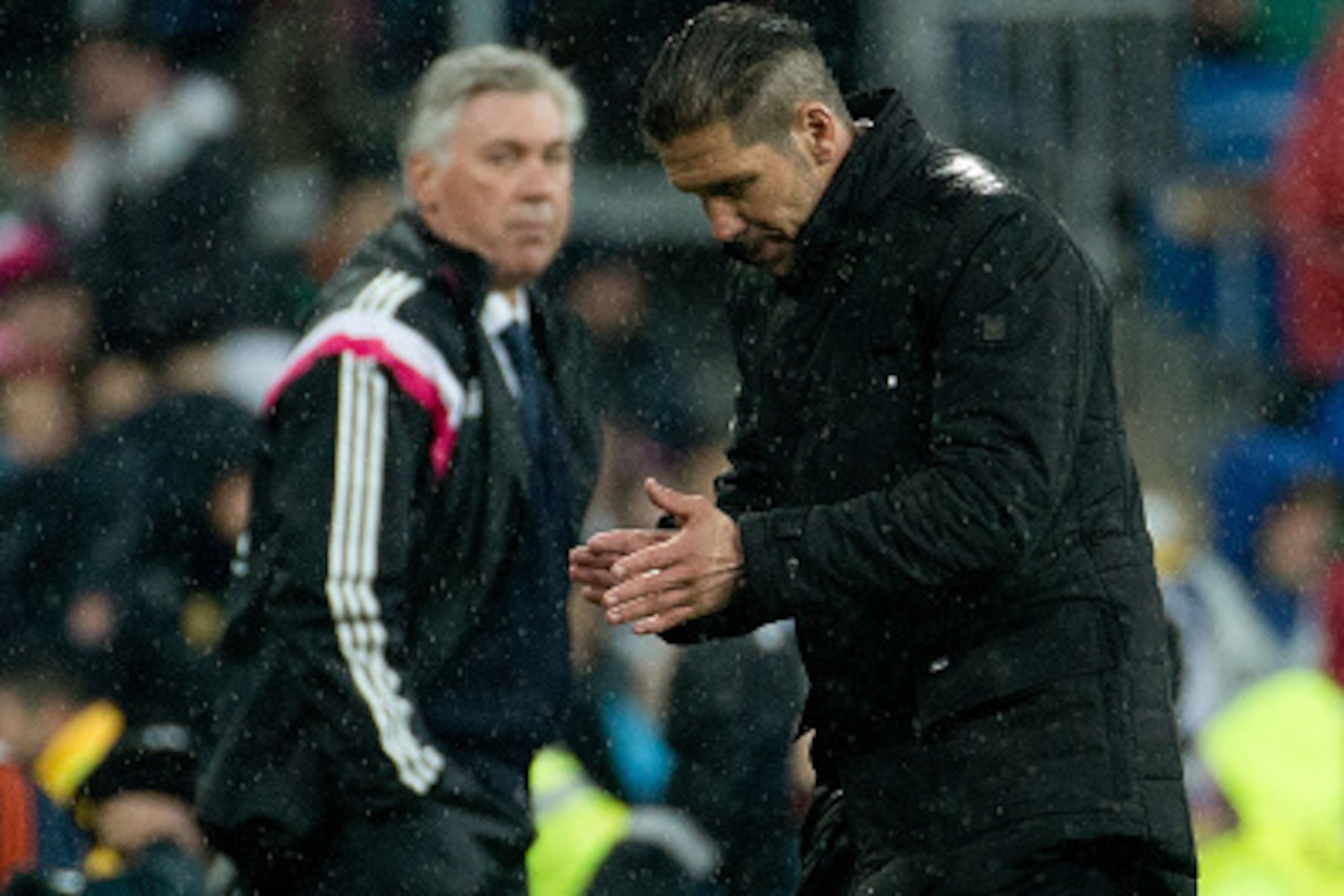 MADRID, SPAIN - JANUARY 15: Head coach Diego Pablo Simeone of Atletico de Madrid claps near head coach Carlo Ancelotti of Real Madrid CF after the Copa del Rey Round of 16  second leg match between Real Madrid CF and Club Atletico de Madrid at Estadio San