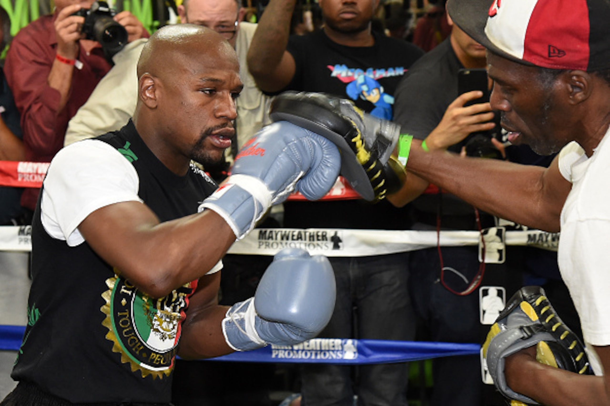LAS VEGAS, NV - APRIL 14:  WBC/WBA welterweight champion Floyd Mayweather Jr. (L) works out with his uncle Roger Mayweather at the Mayweather Boxing Club on April 14, 2015 in Las Vegas, Nevada. Mayweather Jr. will face WBO welterweight champion Manny Pacq