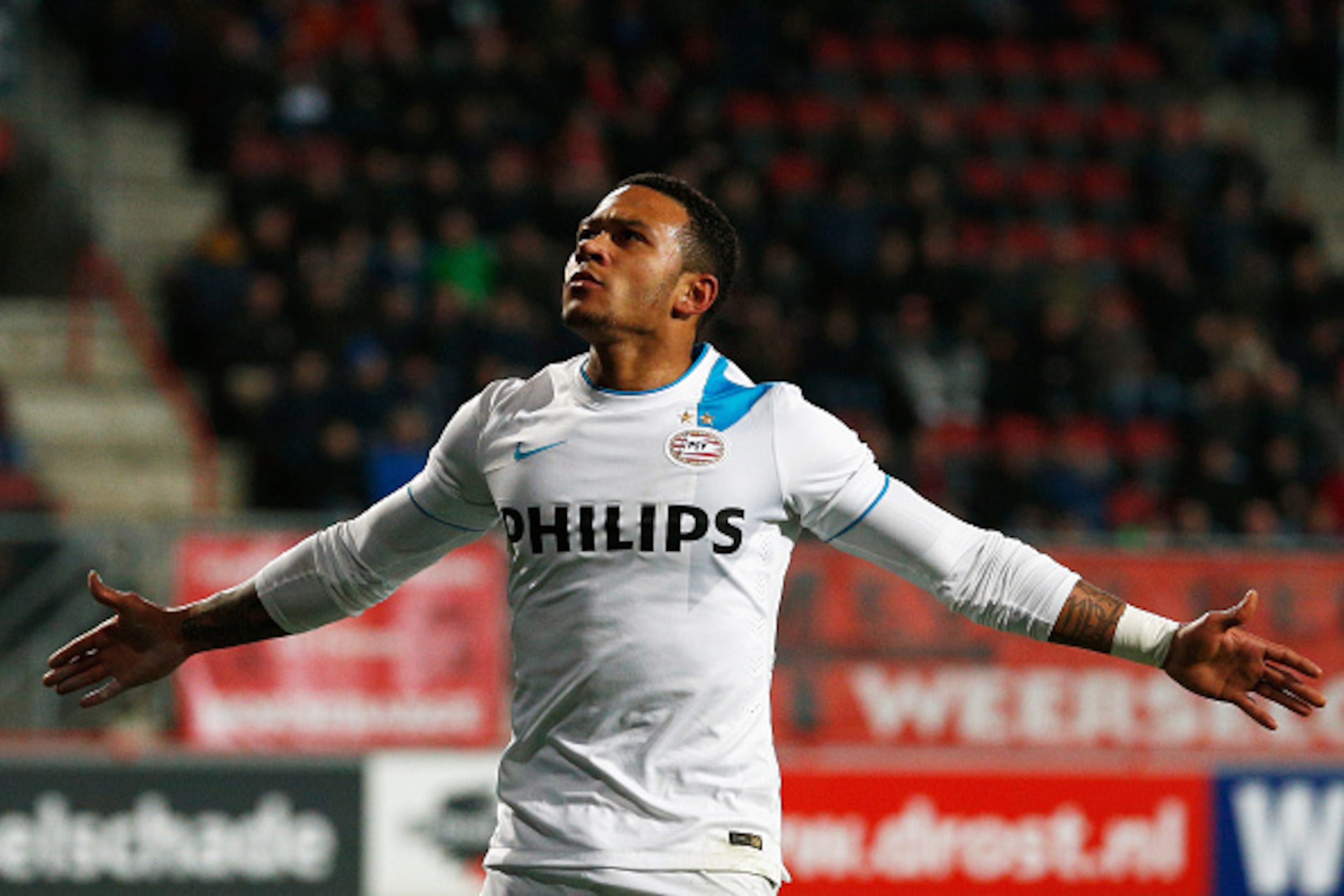 ENSCHEDE, NETHERLANDS - APRIL 04:  Memphis Depay of PSV celebrates after he scores the fifth goal of the game for his team during the Dutch Eredivisie match between FC Twente and PSV Eindhoven held at De Grolsch Veste Stadium on April 4, 2015 in Enschede,