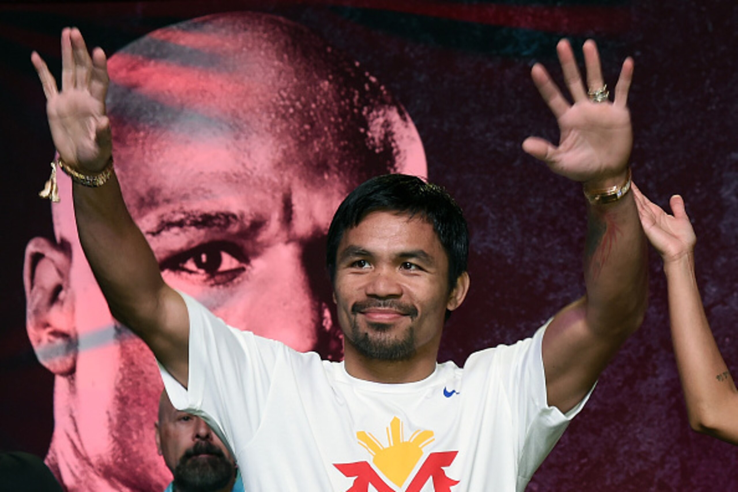 LAS VEGAS, NV - APRIL 28: WBO welterweight champion Manny Pacquiao arrives at a fan rally at the Mandalay Bay Convention Center with his trainer Freddie Roach (L) on April 28, 2015 in Las Vegas, Nevada. Pacquiao will face WBC/WBA welterweight champion Fl LAS VEGAS, NV - APRIL 28: WBO welterweight champion Manny Pacquiao arrives at a fan rally at the Mandalay Bay Convention Center with his trainer Freddie Roach (L) on April 28, 2015 in Las Vegas, Nevada. Pacquiao will face WBC/WBA welterweight champion Fl