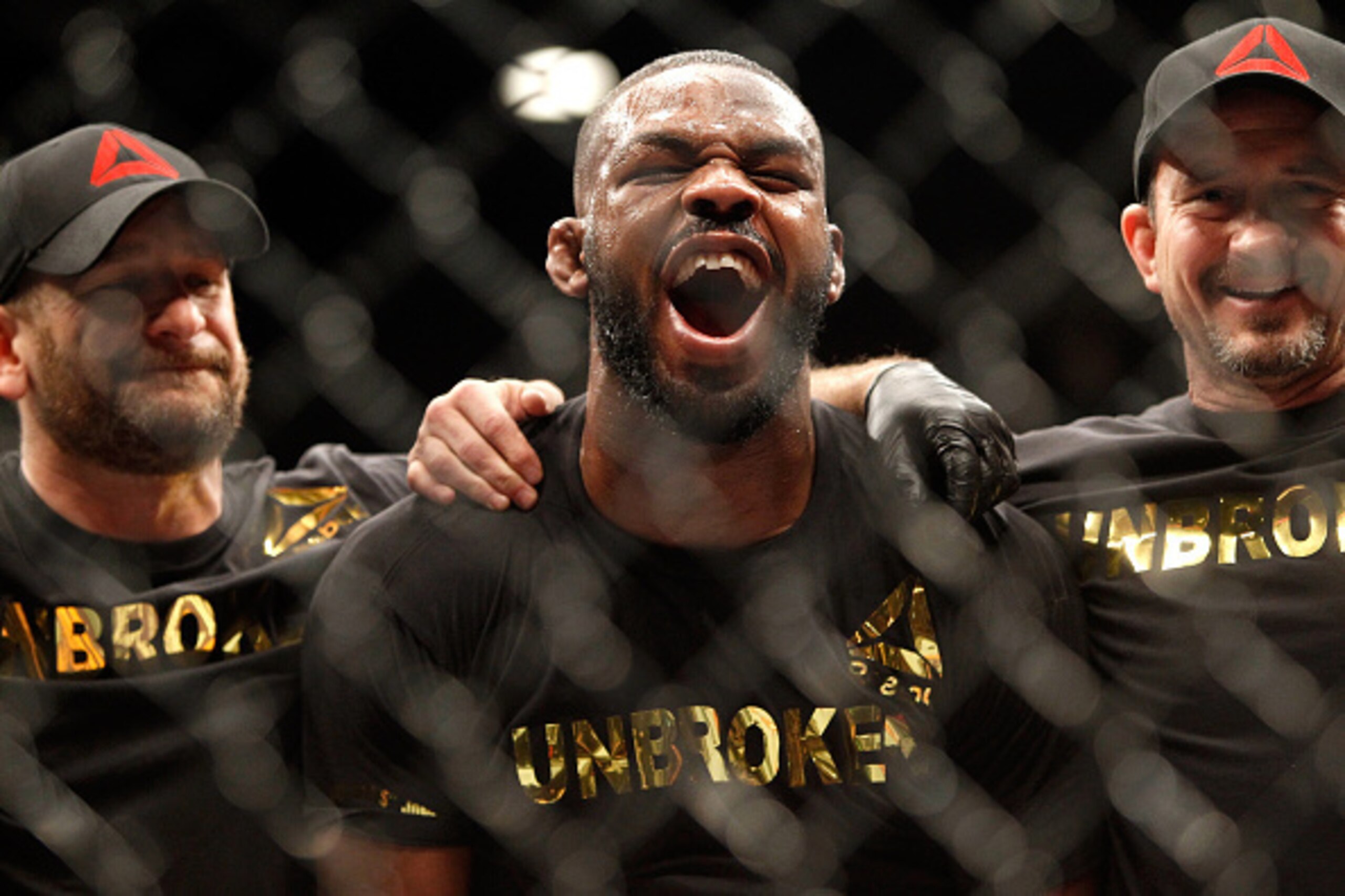 LAS VEGAS, NV - JANUARY 03:  Jon Jones (C) yells out after defeating Daniel Comier in a light heavyweight title fight at the MGM GrandGarden Arena on January 3, 2015 in Las Vegas, Nevada. Jones retained his title by unanimous decision.  (Photo by Steve Ma