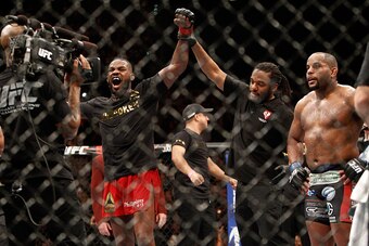 LAS VEGAS, NV - JANUARY 03:  Jon Jones (L) celebrates after defeating Daniel Comier (R) during their light heavyweight title fight at the MGM Grand Garden Arena on January 3, 2015 in Las Vegas, Nevada. Jones retained his title by unanimous decison. (Photo