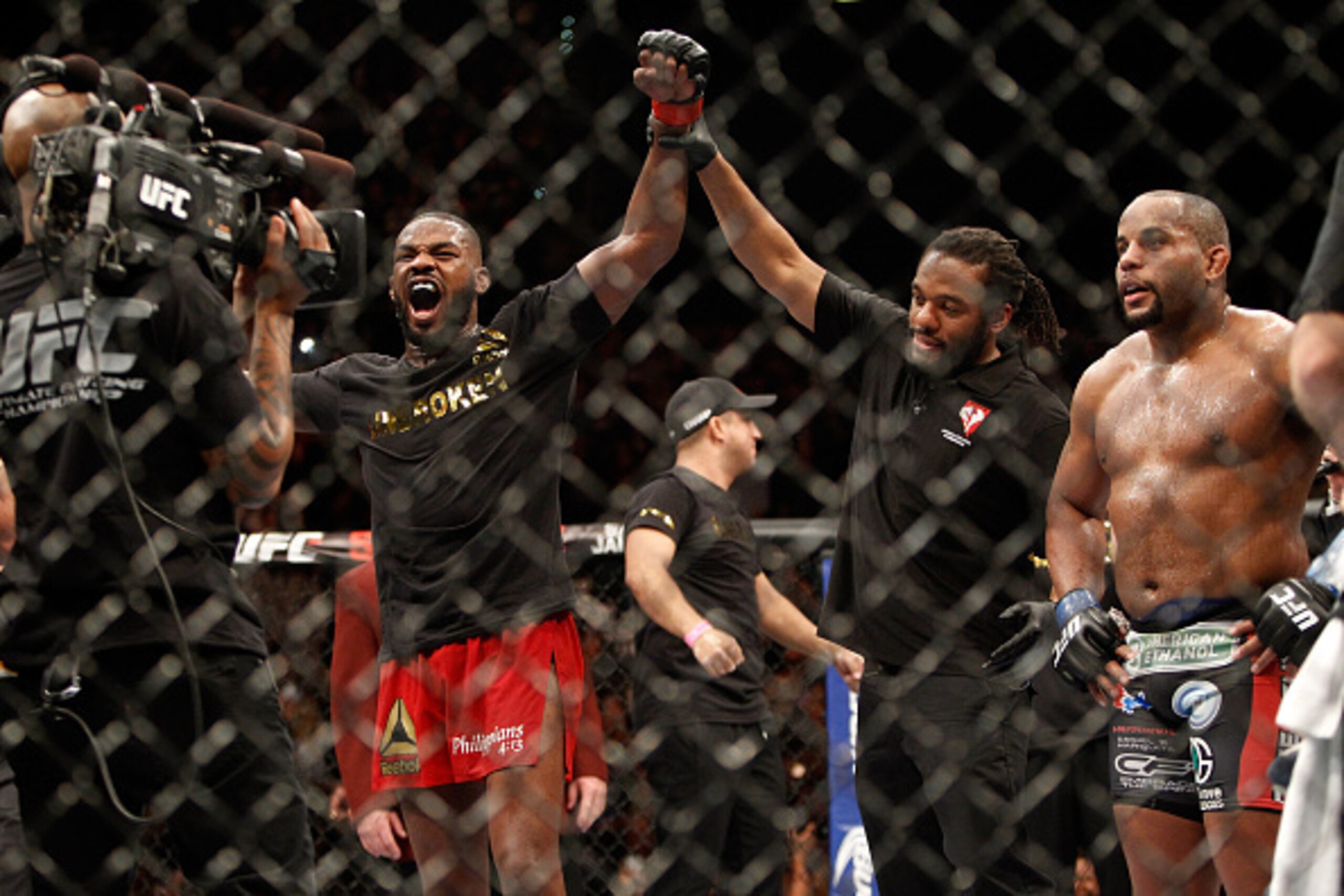 LAS VEGAS, NV - JANUARY 03:  Jon Jones (L) celebrates after defeating Daniel Comier (R) during their light heavyweight title fight at the MGM Grand Garden Arena on January 3, 2015 in Las Vegas, Nevada. Jones retained his title by unanimous decison. (Photo