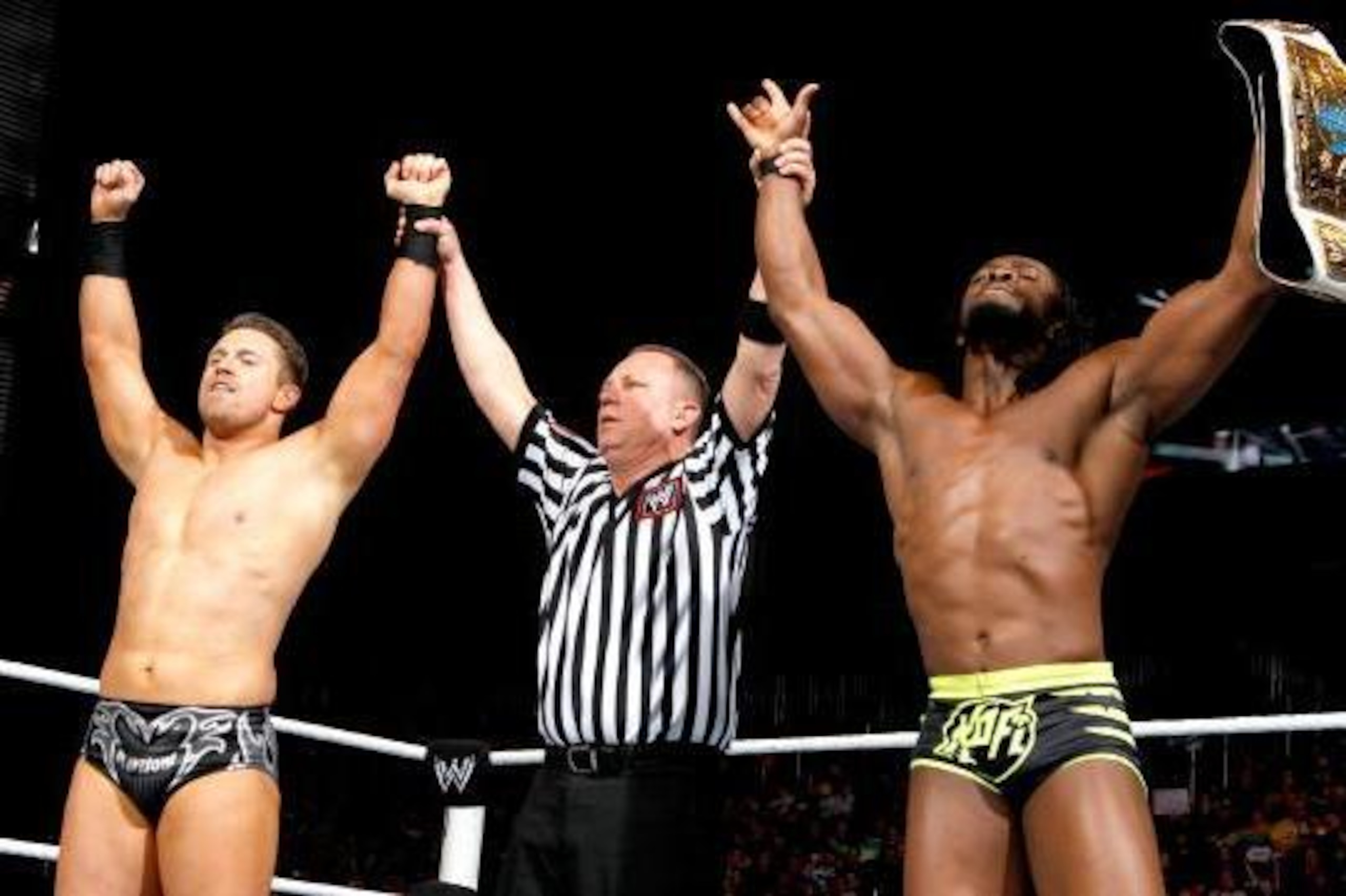 The Miz and Kofi Kingston celebrate a tag team victory.