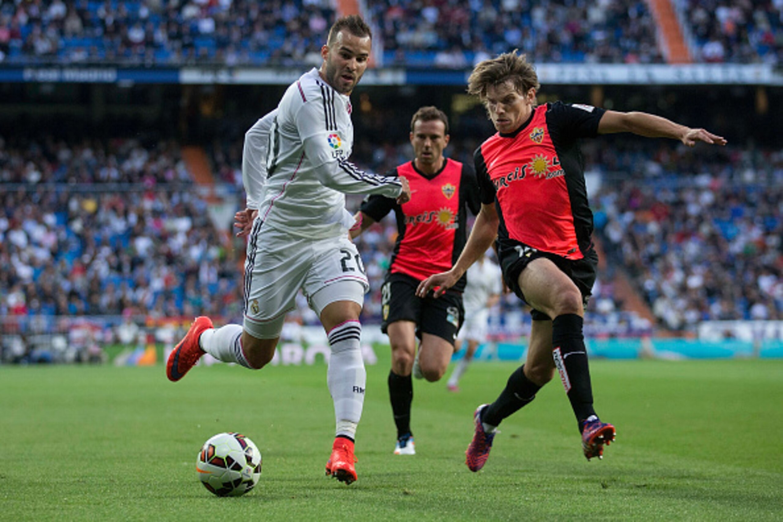 MADRID, SPAIN - APRIL 29: Jese Rodriguez (L) of Real Madrid CF competes for the ball with Sebastian Dubarbier (R) of Almeria UD during the La Liga match between Real Madrid CF and UD Almeria at Estadio Santiago Bernabeu on April 29, 2015 in Madrid, Spain. MADRID, SPAIN - APRIL 29: Jese Rodriguez (L) of Real Madrid CF competes for the ball with Sebastian Dubarbier (R) of Almeria UD during the La Liga match between Real Madrid CF and UD Almeria at Estadio Santiago Bernabeu on April 29, 2015 in Madrid, Spain.