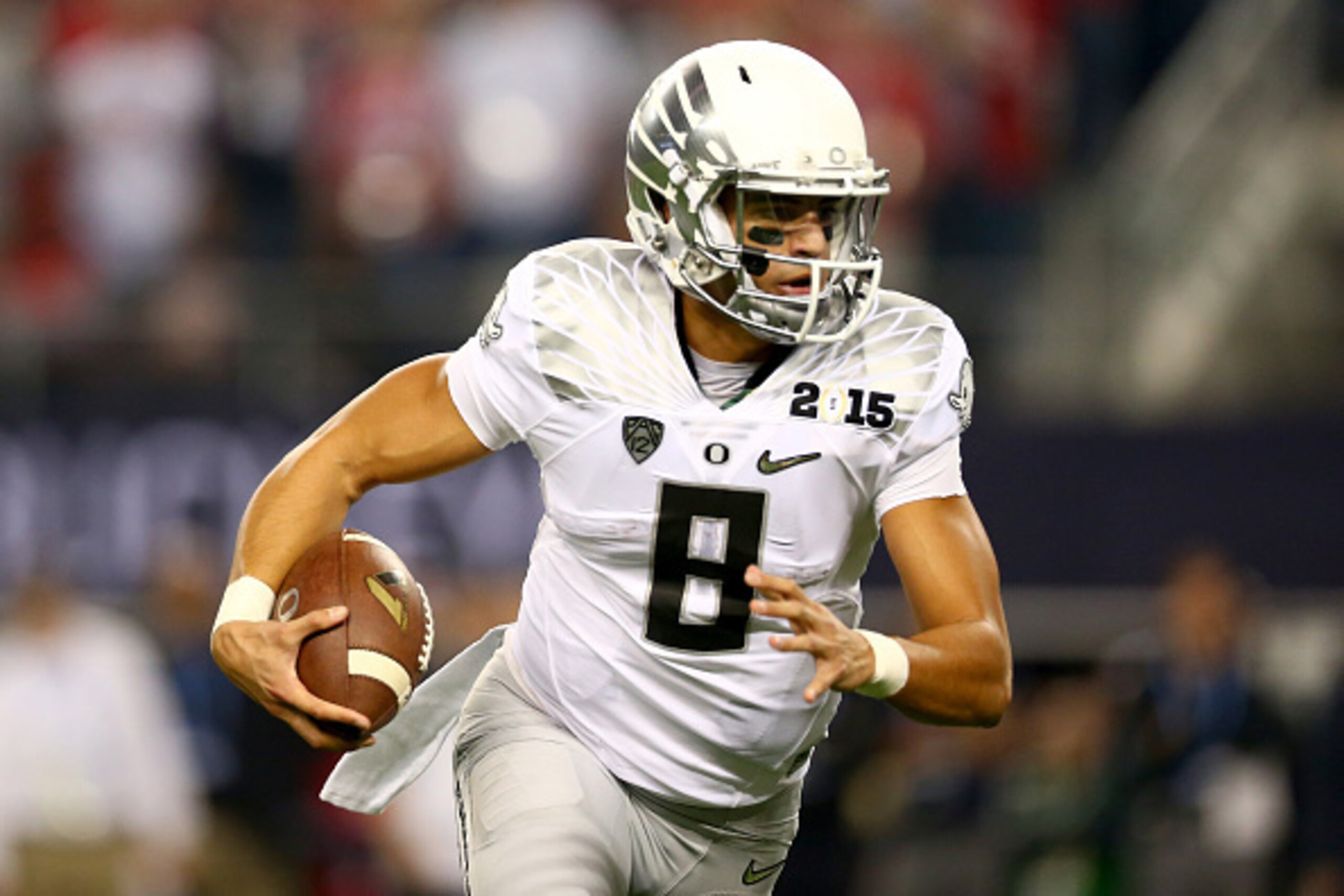 ARLINGTON, TX - JANUARY 12:  Quarterback Marcus Mariota #8 of the Oregon Ducks runs the ball against the Ohio State Buckeyes during the College Football Playoff National Championship Game at AT&T Stadium on January 12, 2015 in Arlington, Texas.  (Photo by