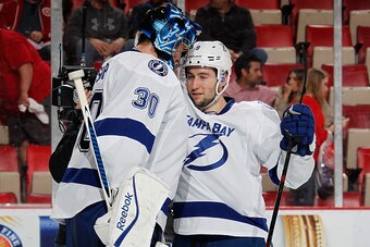 DETROIT, MI - APRIL 27:  Tyler Johnson #9 of the Tampa Bay Lightning celebrates a 5-2 win over the Detroit Red Wings with Ben Bishop #30 in Game Six of the Eastern Conference Quarterfinals against the Detroit Red Wings during the 2015 NHL Stanley Cup Play