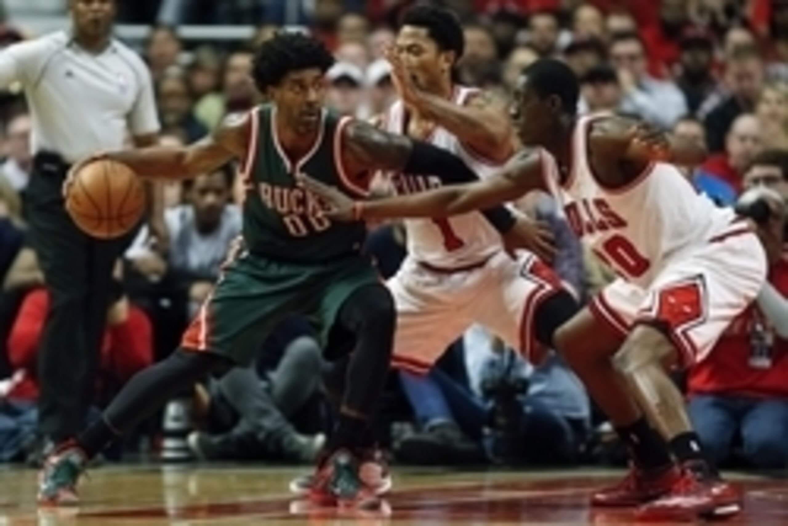 Apr 27, 2015; Chicago, IL, USA; Milwaukee Bucks guard O.J. Mayo (00) is defended by Chicago Bulls guard Derrick Rose (1) and forward Tony Snell (20) in game five of the first round of the 2015 NBA Playoffs at United Center. The Bucks won 94-88. Mandatory 
