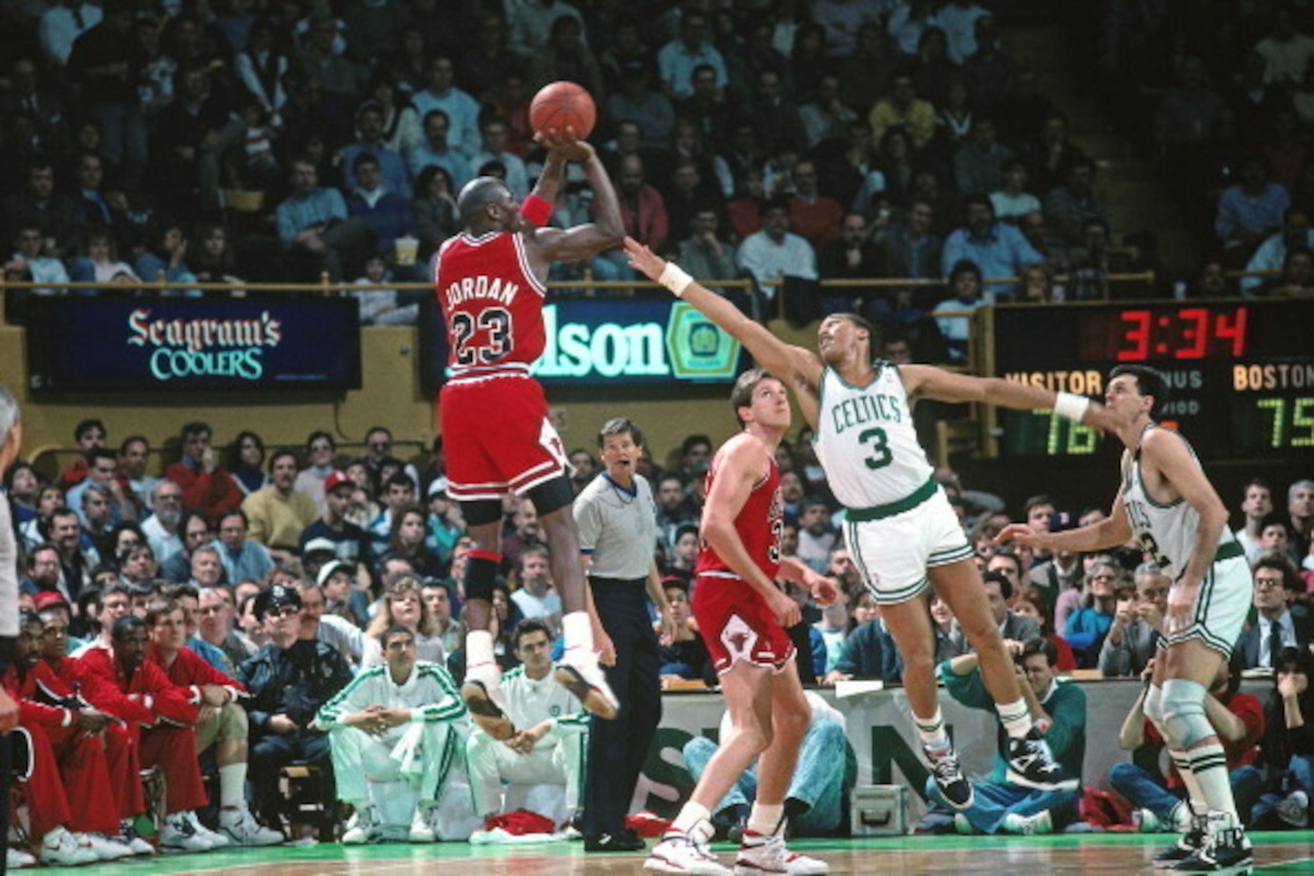 BOSTON, MA - 1990: Michael Jordan #23 of the Chicago Bulls shoots against Dennis Johnson #3 of the Boston Celtics during a game played circa 1990 at the Boston Garden in Boston, Massachusetts. NOTE TO USER: User expressly acknowledges and agrees that, by 