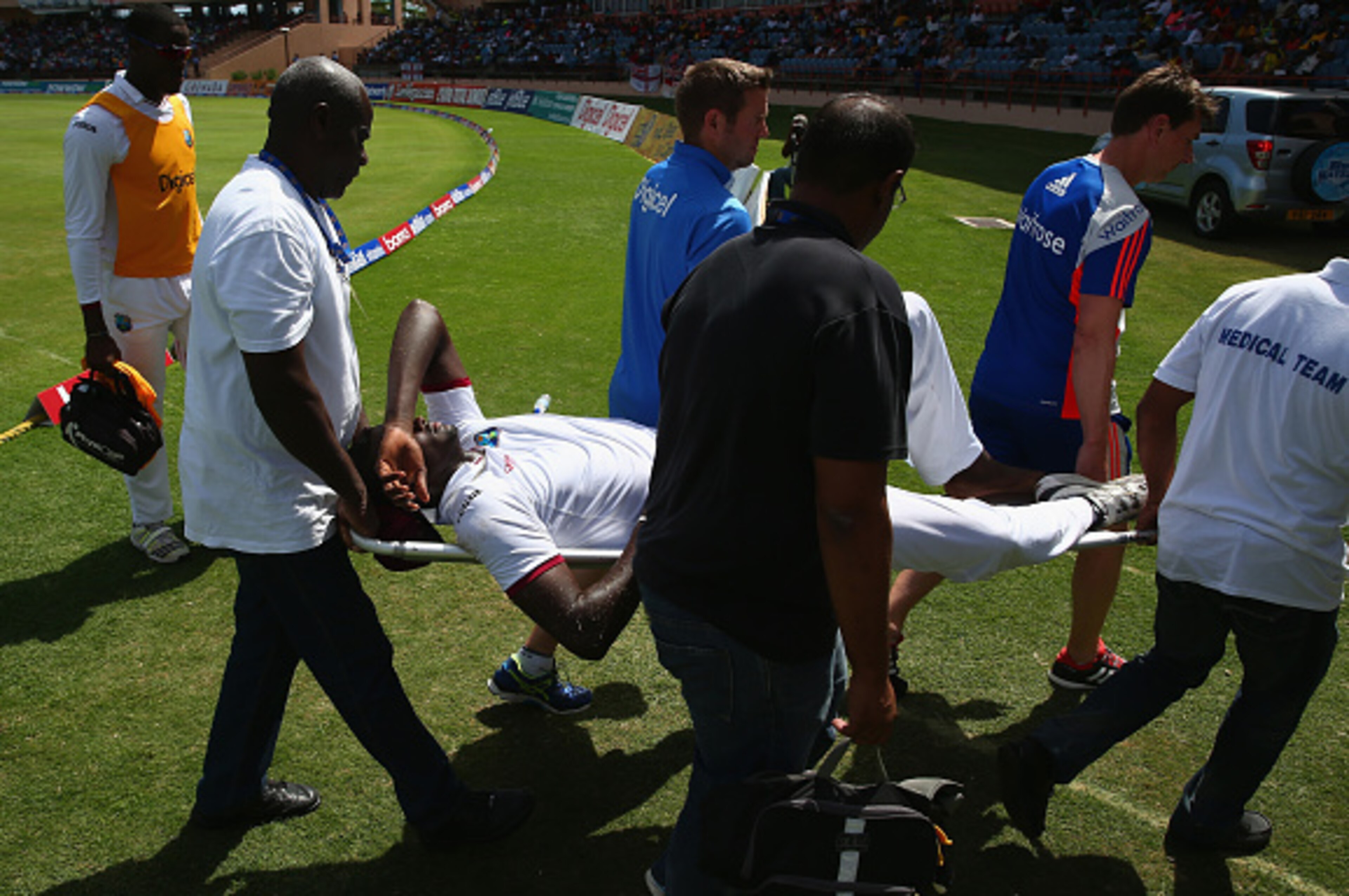 GRENADA, GRENADA - APRIL 25:  Jason Holder of West Indies is stretchered off the field of play after injuring himself whilst bowling during day five of the 2nd Test match between West Indies and England at the National Cricket Stadium in St George's  on A