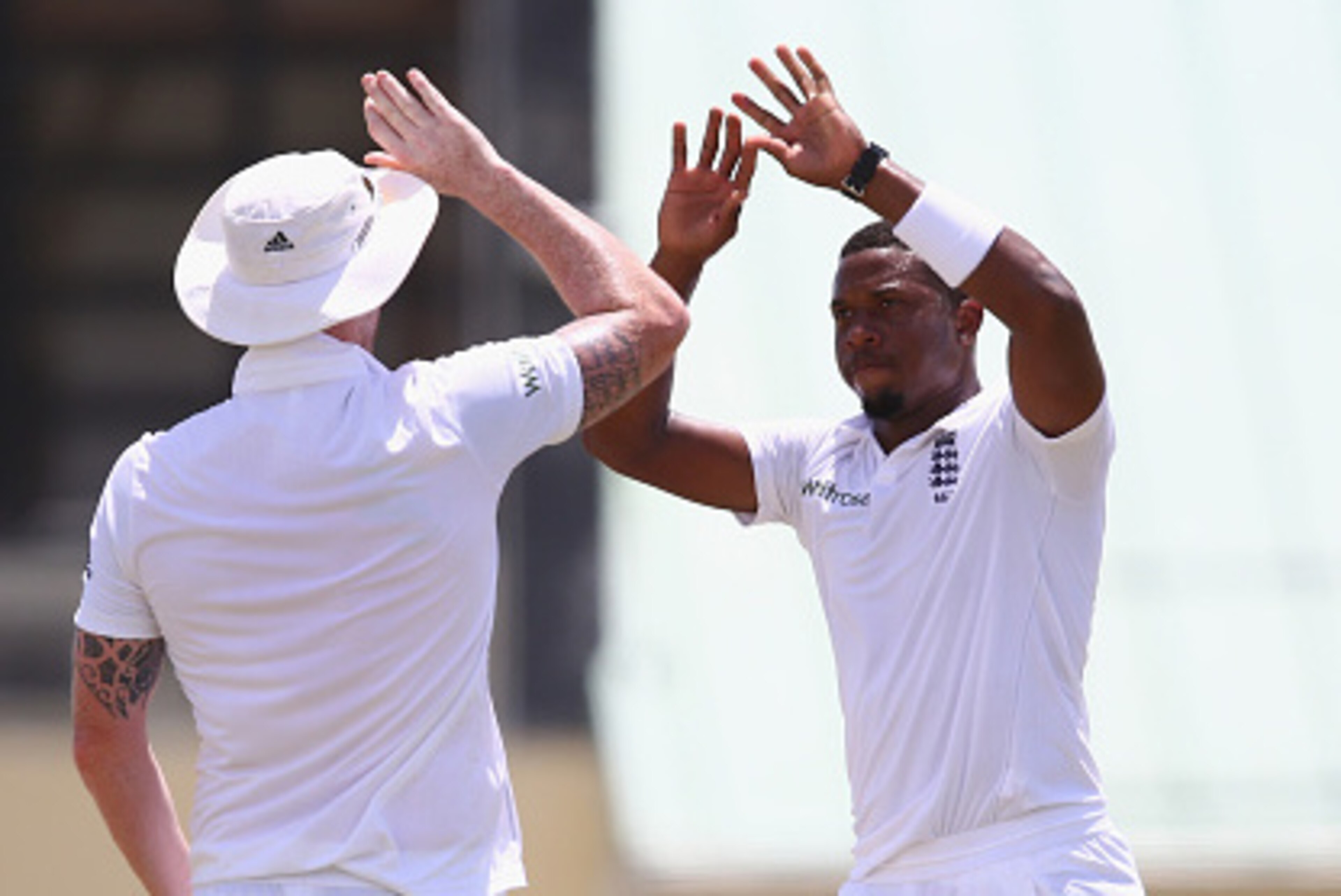 BASSETERRE, ST KITTS, SAINT KITTS AND NEVIS - APRIL 06:  Chris Jordan (R) of England celebrates with Ben Stokes (L) after capturing the wicket of Akeem Saunders of St Kitts and Nevis Invitational XI during the St Kitts and Nevis Invitational XI versus  En