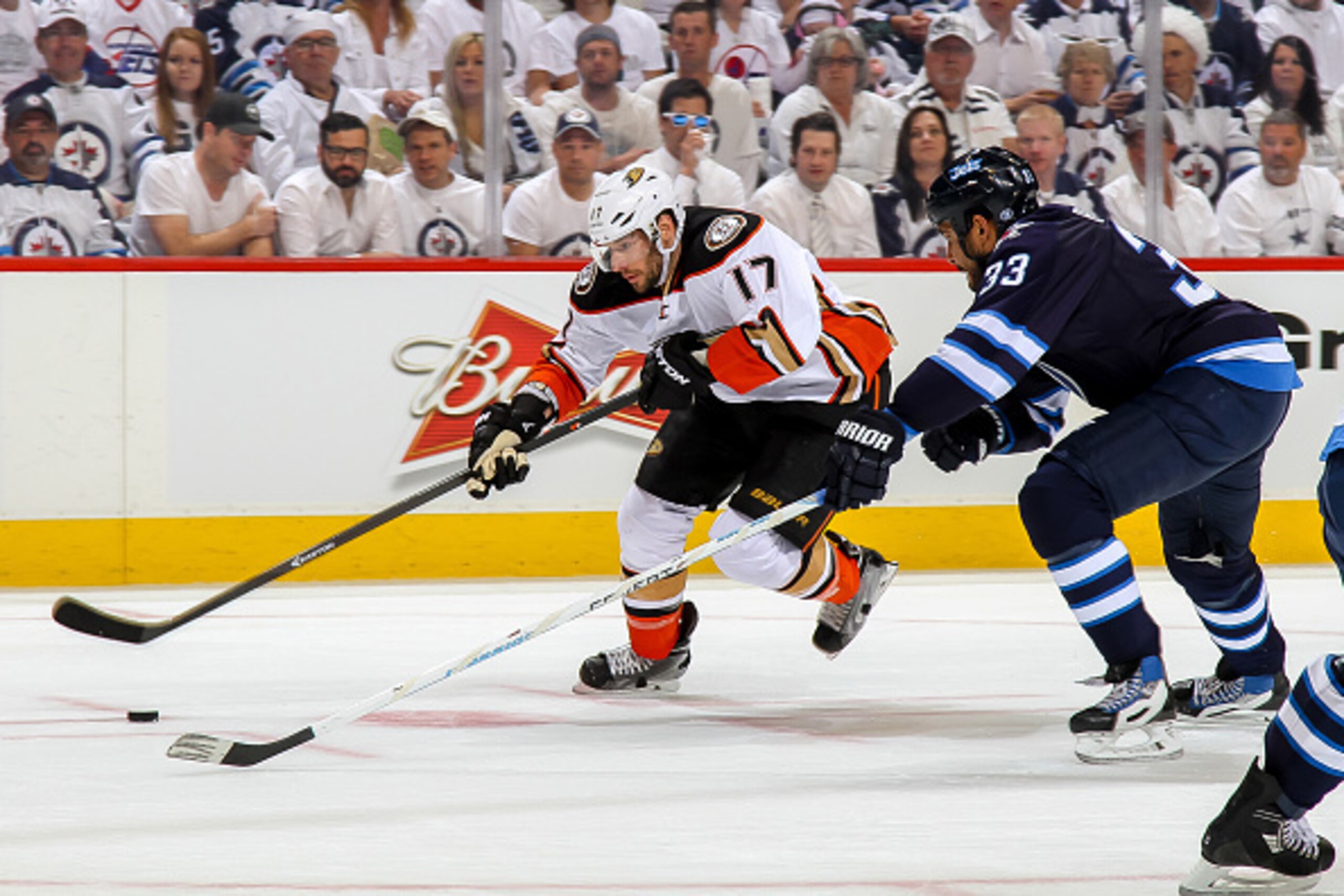 WINNIPEG, CANADA - APRIL 22: Ryan Kesler #17 of the Anaheim Ducks plays the puck down the ice as Dustin Byfuglien #33 of the Winnipeg Jets defends during first period action in Game Four of the Western Conference Quarterfinals during the 2015 NHL Stanley 