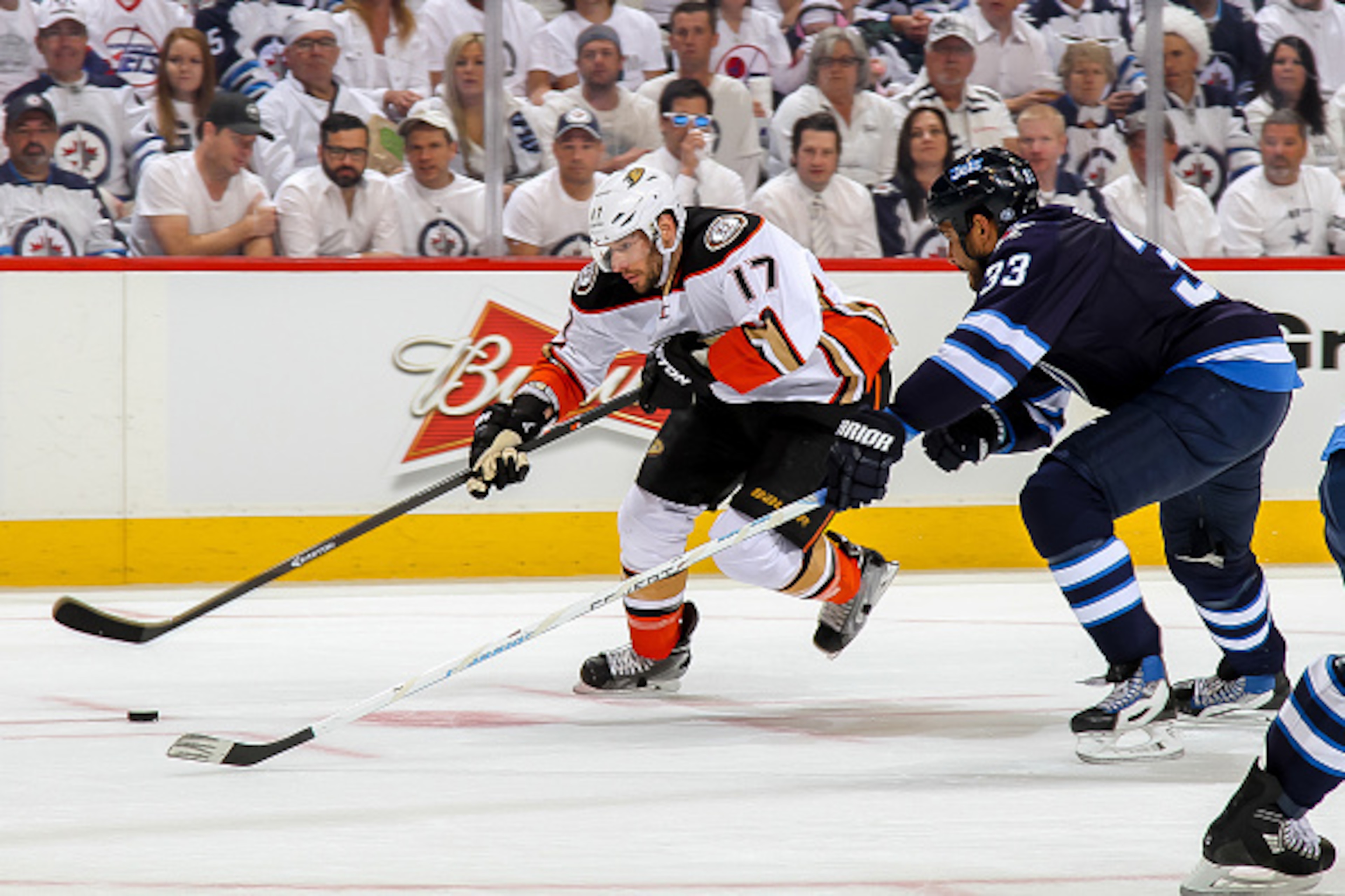WINNIPEG, CANADA - APRIL 22: Ryan Kesler #17 of the Anaheim Ducks plays the puck down the ice as Dustin Byfuglien #33 of the Winnipeg Jets defends during first period action in Game Four of the Western Conference Quarterfinals during the 2015 NHL Stanley 