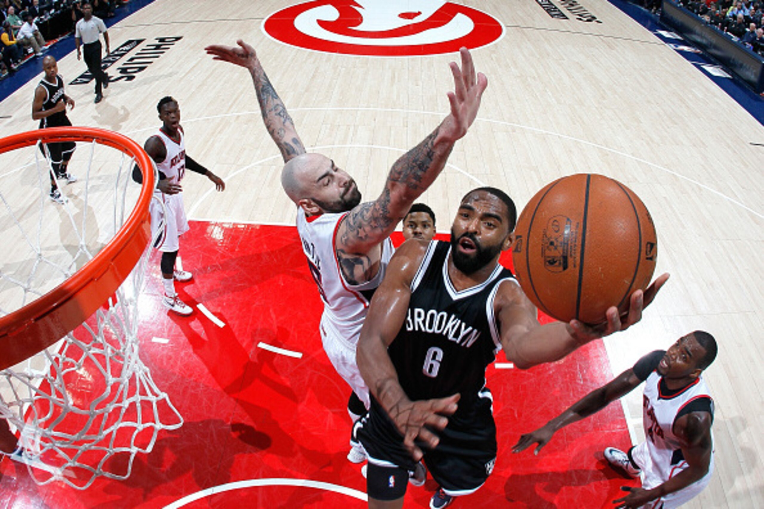 ATLANTA, GA - APRIL 29:  Alan Anderson #6 of the Brooklyn Nets drives against Pero Antic #6 and Paul Millsap #4 of the Atlanta Hawks during Game Five of the Eastern Conference Quarterfinals of the NBA Playoffs at Philips Arena on April 29, 2015 in Atlanta