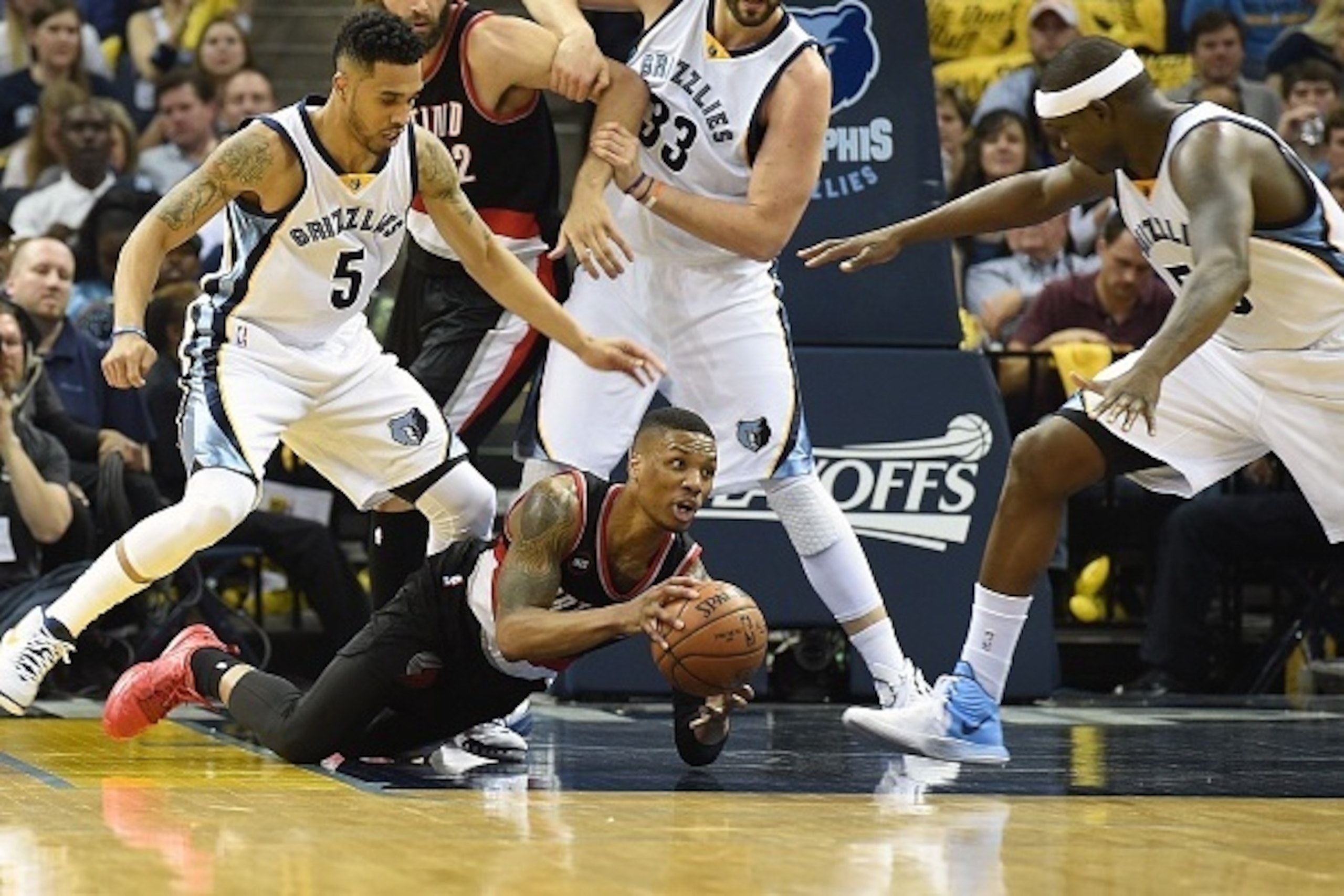 MEMPHIS, TN - APRIL 29:  Damian Lillard #0 of the Portland Trailblazers dives for a loose ball in front of Courtney Lee #5, Marc Gasol #33, and Zach Randolph #50 of the Memphis Grizzlies during the first quarter of Game 5 of the first round of the 2015 NB
