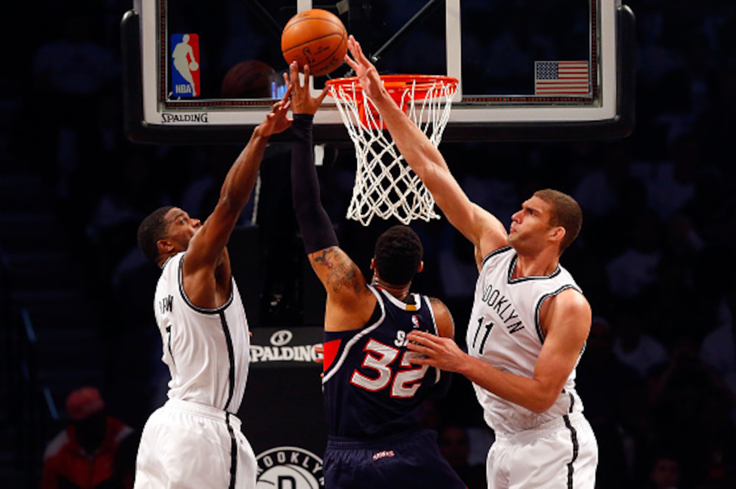 BROOKLYN, NY - APRIL 27:  Brook Lopez #11 and Joe Johnson #7 of the Brooklyn Nets defend a shot in the first half against Mike Scott #32 of the Atlanta Hawks during game four in the first round of the 2015 NBA Playoffs at Barclays Center on April 27, 2015