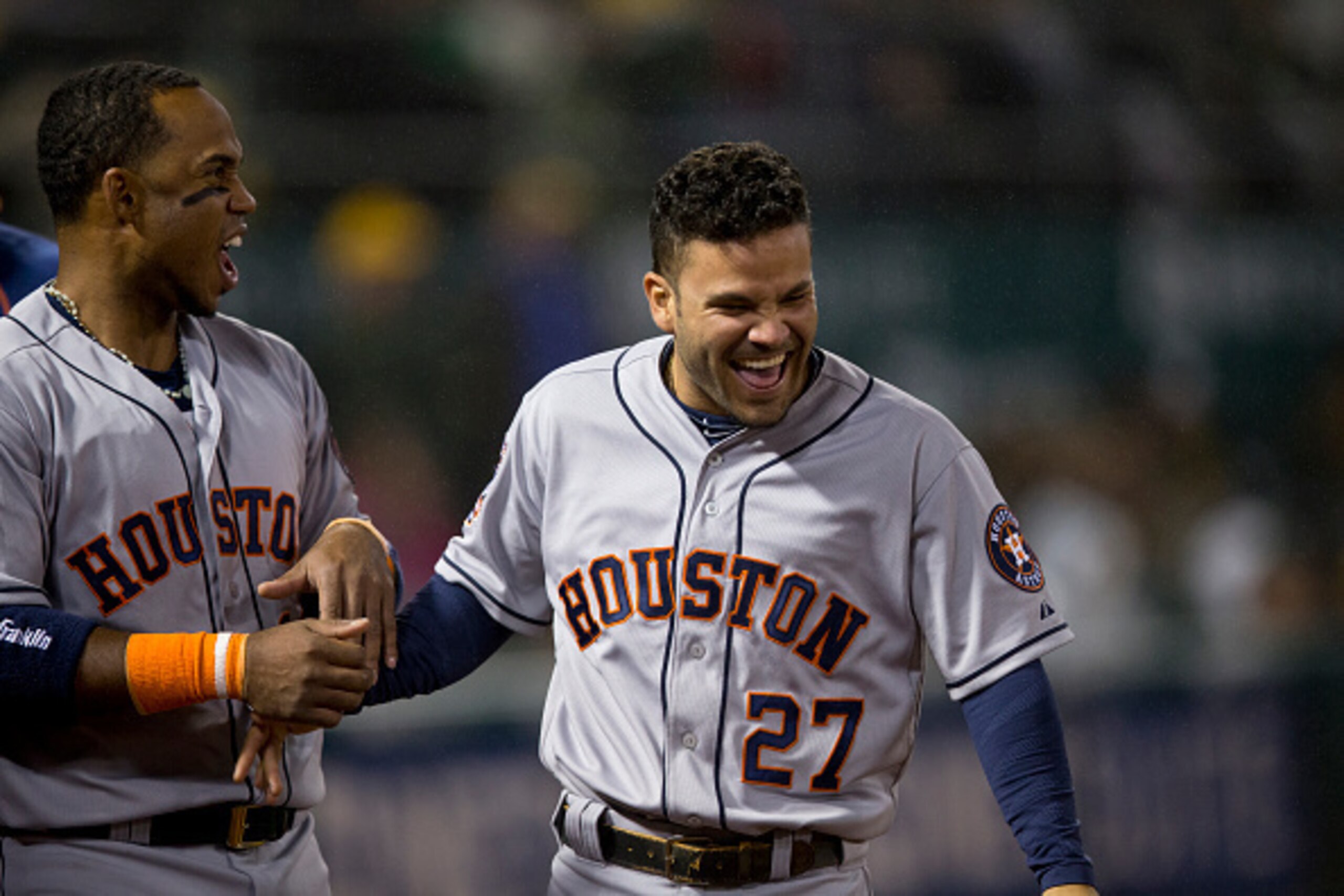 OAKLAND, CA - APRIL 24:  Jose Altuve #27 of the Houston Astros celebrates with Luis Valbuena #18 in the dugout during the tenth inning against the Oakland Athletics at O.co Coliseum on April 24, 2015 in Oakland, California. (Photo by Jason O. Watson/Getty