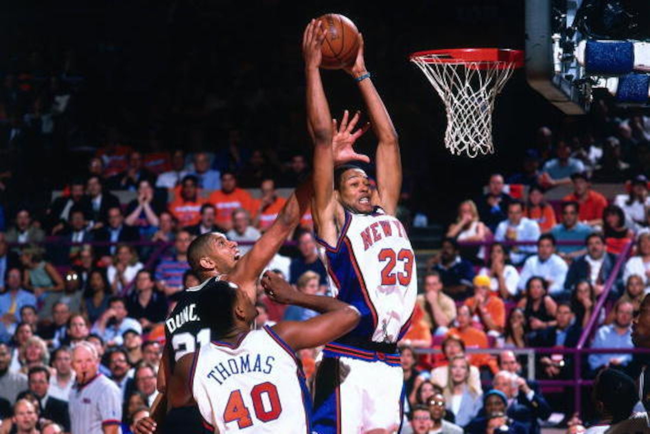 NEW YORK - JUNE 23:  Marcus Camby #21 of the New York Knicks grabs the rebound during Game Four of the 1999 NBA Finals played on June 23, 1999 at Madison Square Garden in New York, New York.  NOTE TO USER: User expressly acknowledges that, by downloading 