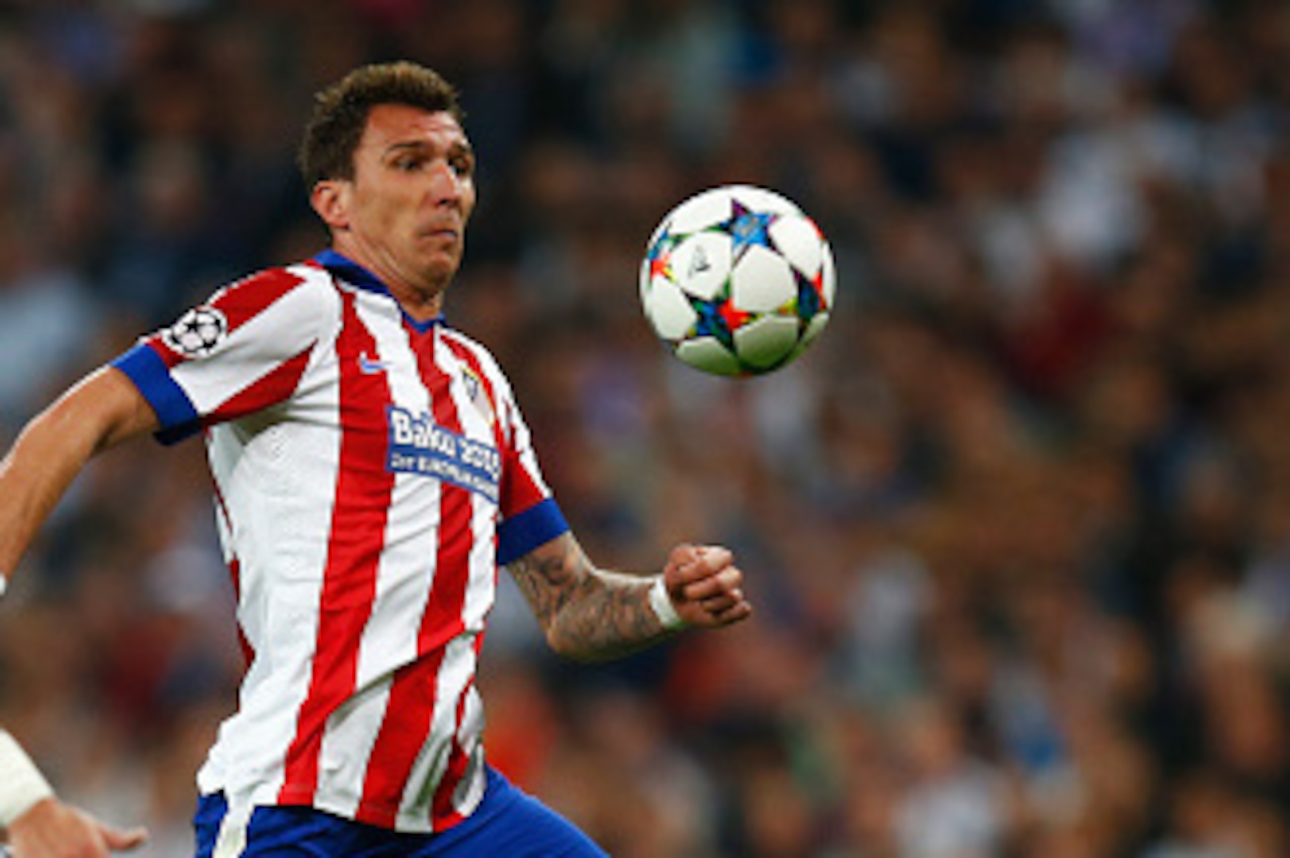 MADRID, SPAIN - APRIL 22:  Mario Mandzukic of Atletico Madrid takes on Pepe of Real Madrid CF during the UEFA Champions League quarter-final second leg match between Real Madrid CF and Club Atletico de Madrid at Bernabeu on April 22, 2015 in Madrid, Spain