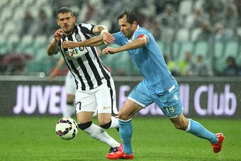 TURIN, ITALY - APRIL 18:  Stefano Sturaro of Juventus FC competes for the ball with Senad Lulic of SS Lazio during the Serie A match between Juventus FC and SS Lazio at Juventus Arena on April 18, 2015 in Turin, Italy.  (Photo by Marco Luzzani/Getty Image