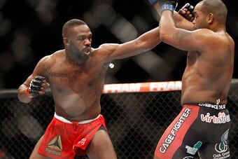 LAS VEGAS, NV - JANUARY 03:  Light heavyweight champion Jon Jones punches at Daniel Comier during the UFC 182 event at the MGM Grand Garden Arena on January 3, 2015 in Las Vegas, Nevada. Jones retained his title by unanimous decision.  (Photo by Steve Mar