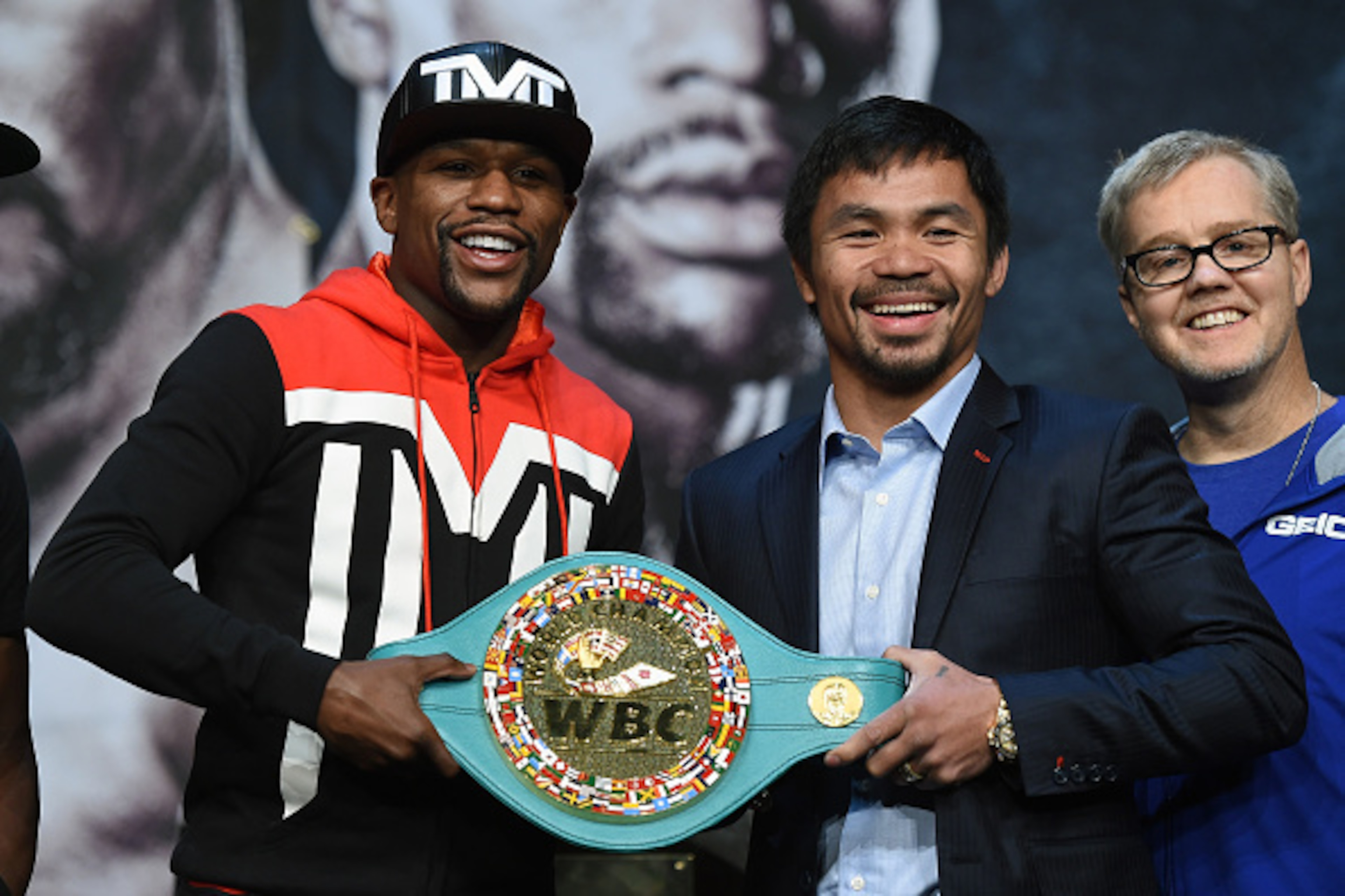 LAS VEGAS, NV - APRIL 29: (L-R) WBC/WBA welterweight champion Floyd Mayweather Jr. and WBO welterweight champion Manny Pacquiao pose with a WBC championship belt as Pacquiao's trainer Freddie Roach looks on during a news conference at the KA Theatre at M LAS VEGAS, NV - APRIL 29: (L-R) WBC/WBA welterweight champion Floyd Mayweather Jr. and WBO welterweight champion Manny Pacquiao pose with a WBC championship belt as Pacquiao's trainer Freddie Roach looks on during a news conference at the KA Theatre at M