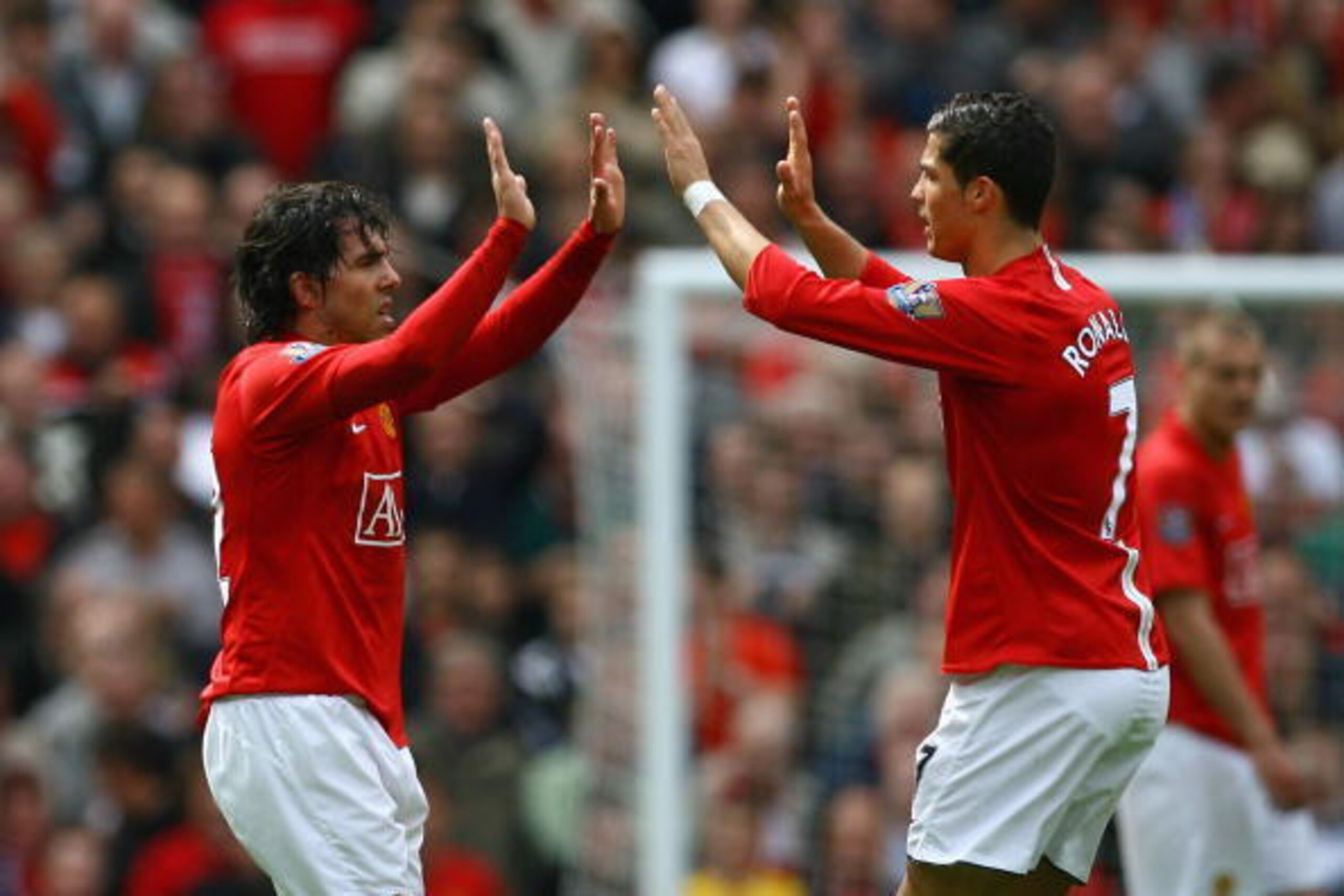 MANCHESTER, ENGLAND - MAY 10: Cristiano Ronaldo of Manchester United congratulates team mate Carlos Tevez after he scored his team's second goal during the Barclays Premier League match between Manchester United and Manchester City at Old Trafford on May MANCHESTER, ENGLAND - MAY 10: Cristiano Ronaldo of Manchester United congratulates team mate Carlos Tevez after he scored his team's second goal during the Barclays Premier League match between Manchester United and Manchester City at Old Trafford on May