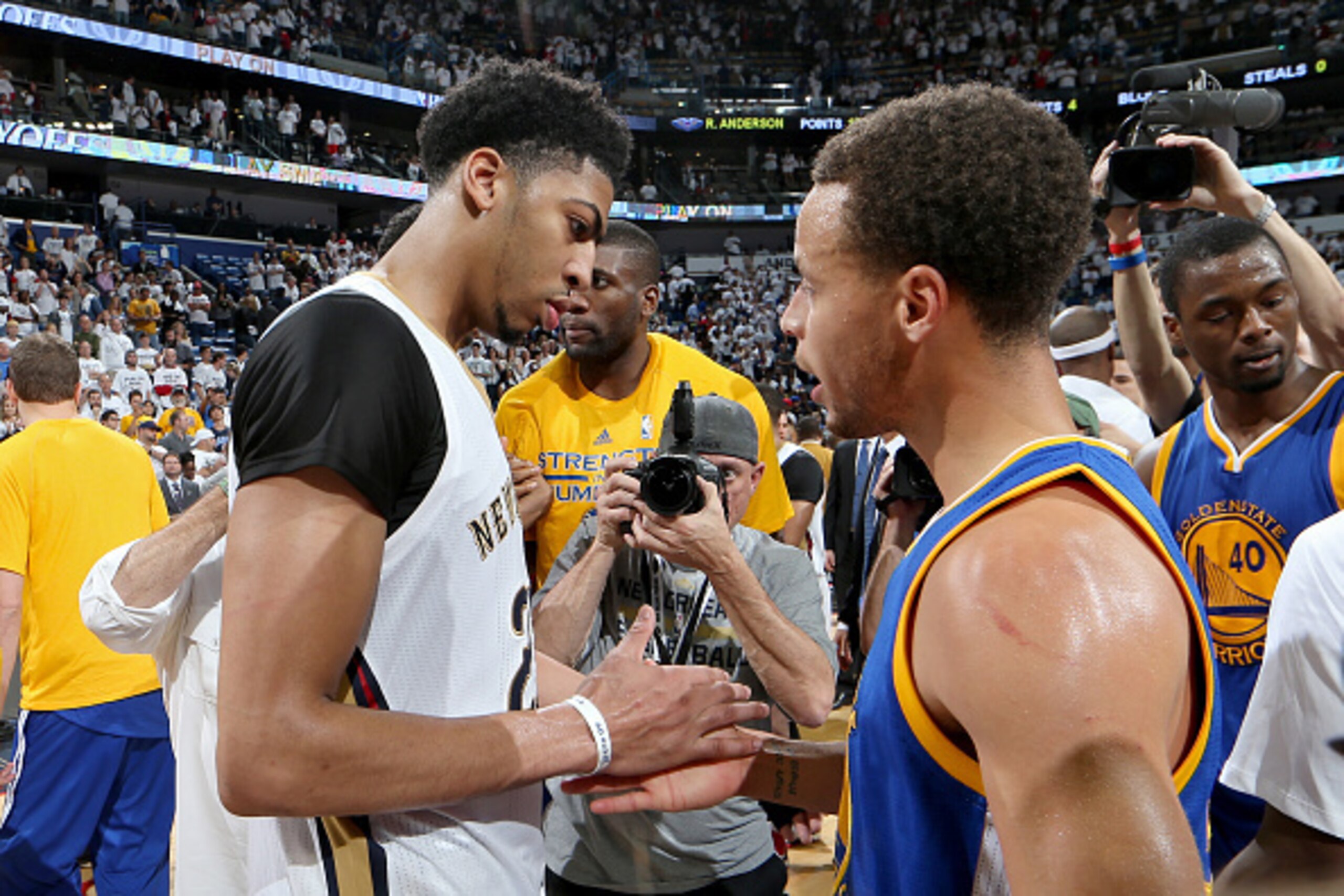 NEW ORLEANS, LA - APRIL 25: Anthony Davis #23 of the New Orleans Pelicans high fives with Stephen Curry #30 of the Golden State Warriors after Game Four of the Western Conference Quarterfinals during the 2015 NBA Playoffs on April 25, 2015 at the Smoothie